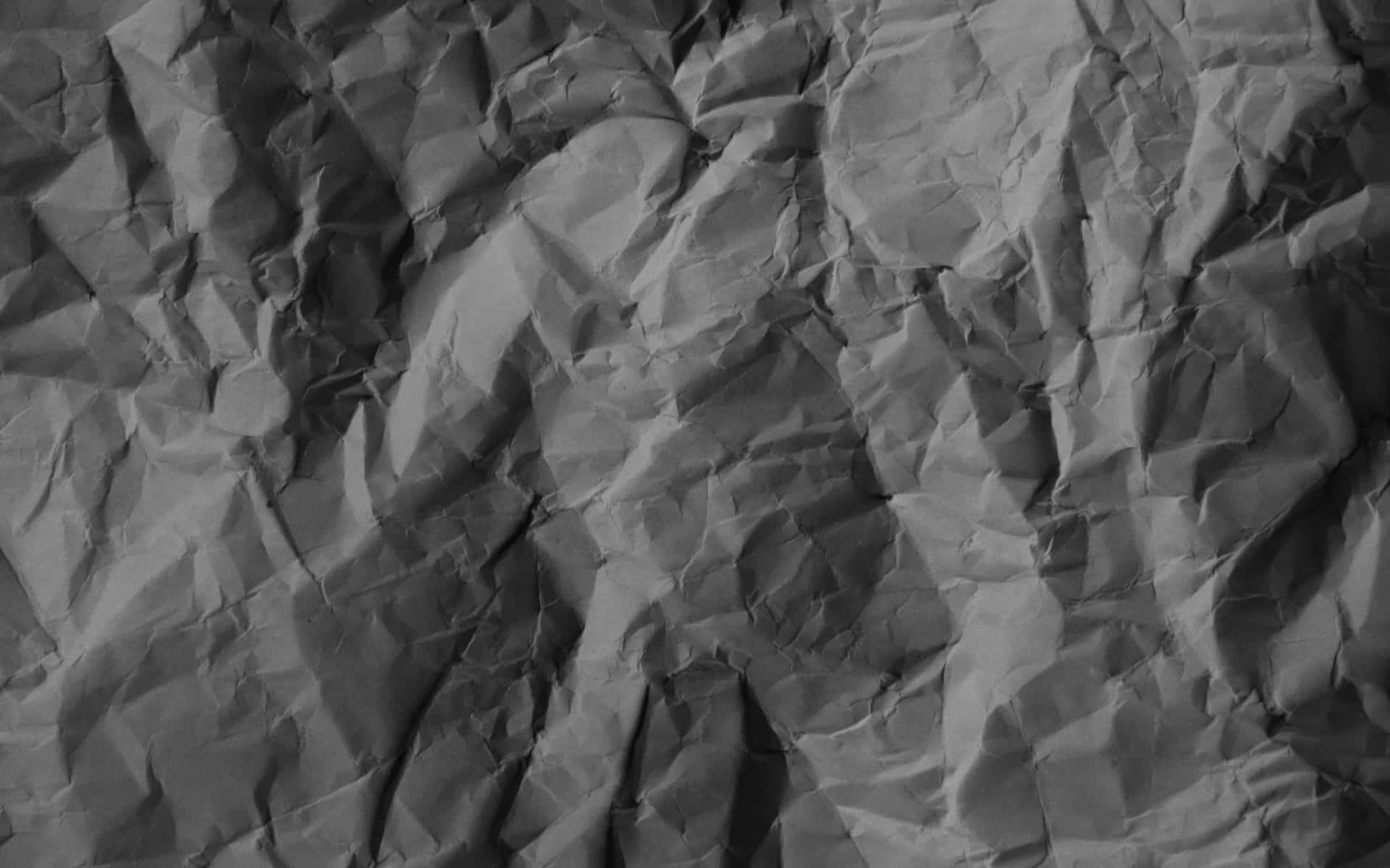A Black And White Image Of Crumpled Paper