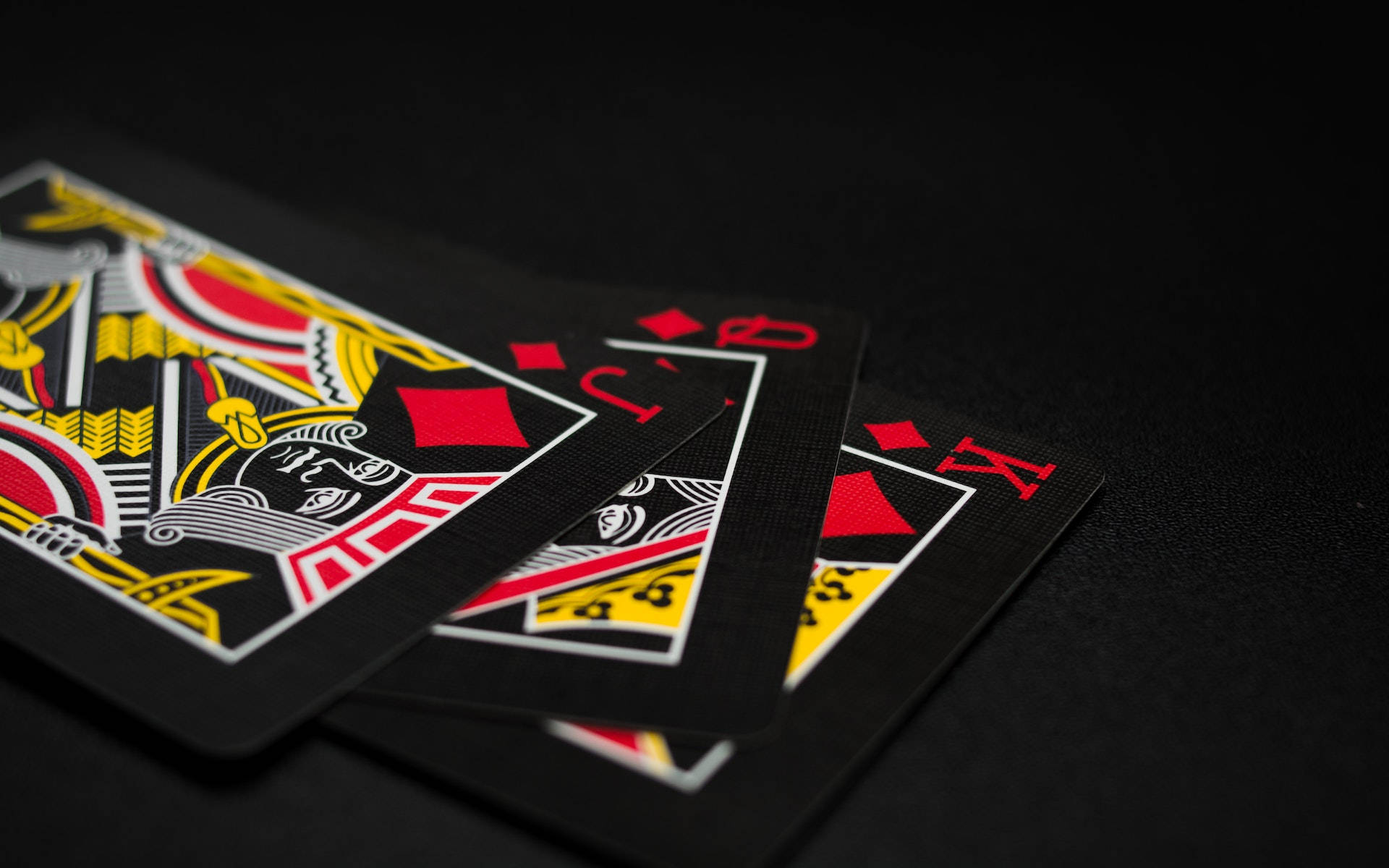"Stylish Black Playing Cards Laid Out on a Black PC" Wallpaper