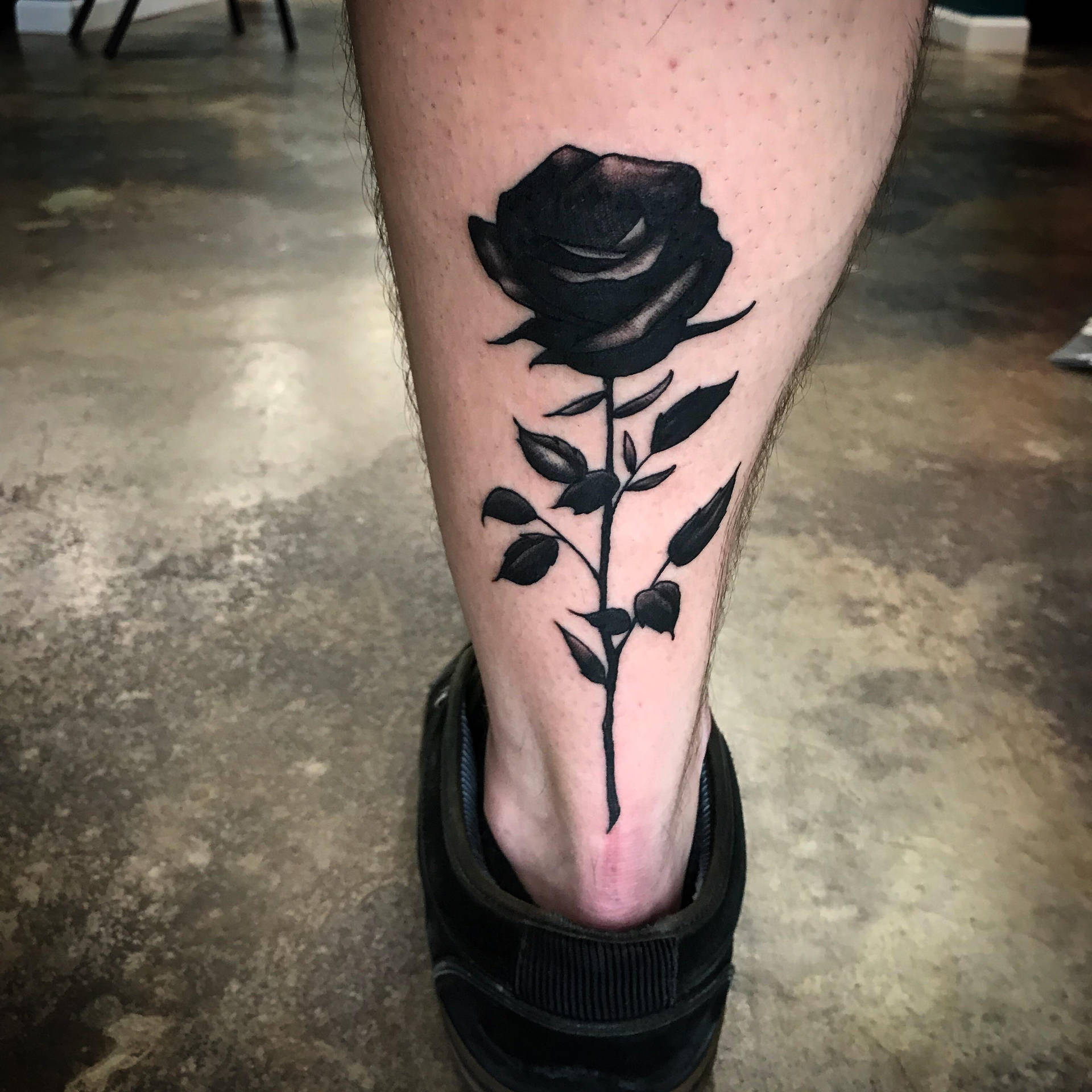 Intricate Black Rose Tattoo Design on Leg Wallpaper