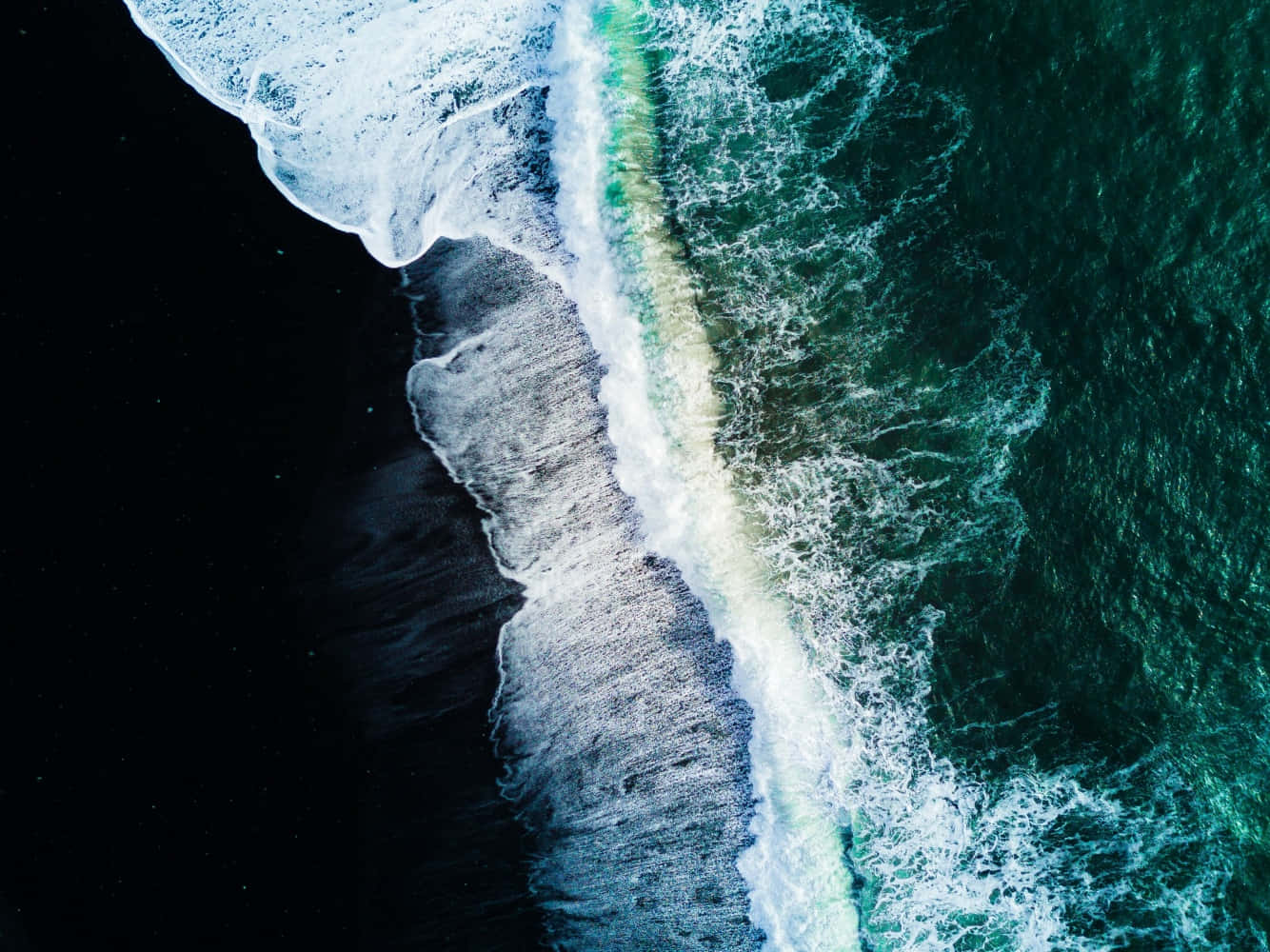 The Beautiful Black Sand Beach on a Sunny Day Wallpaper