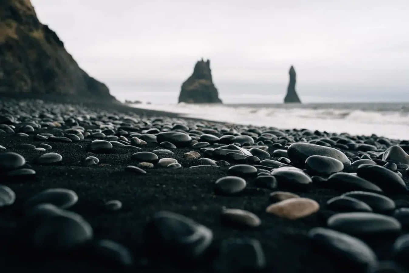 The beauty of a black sand beach in the Mediterranean Wallpaper