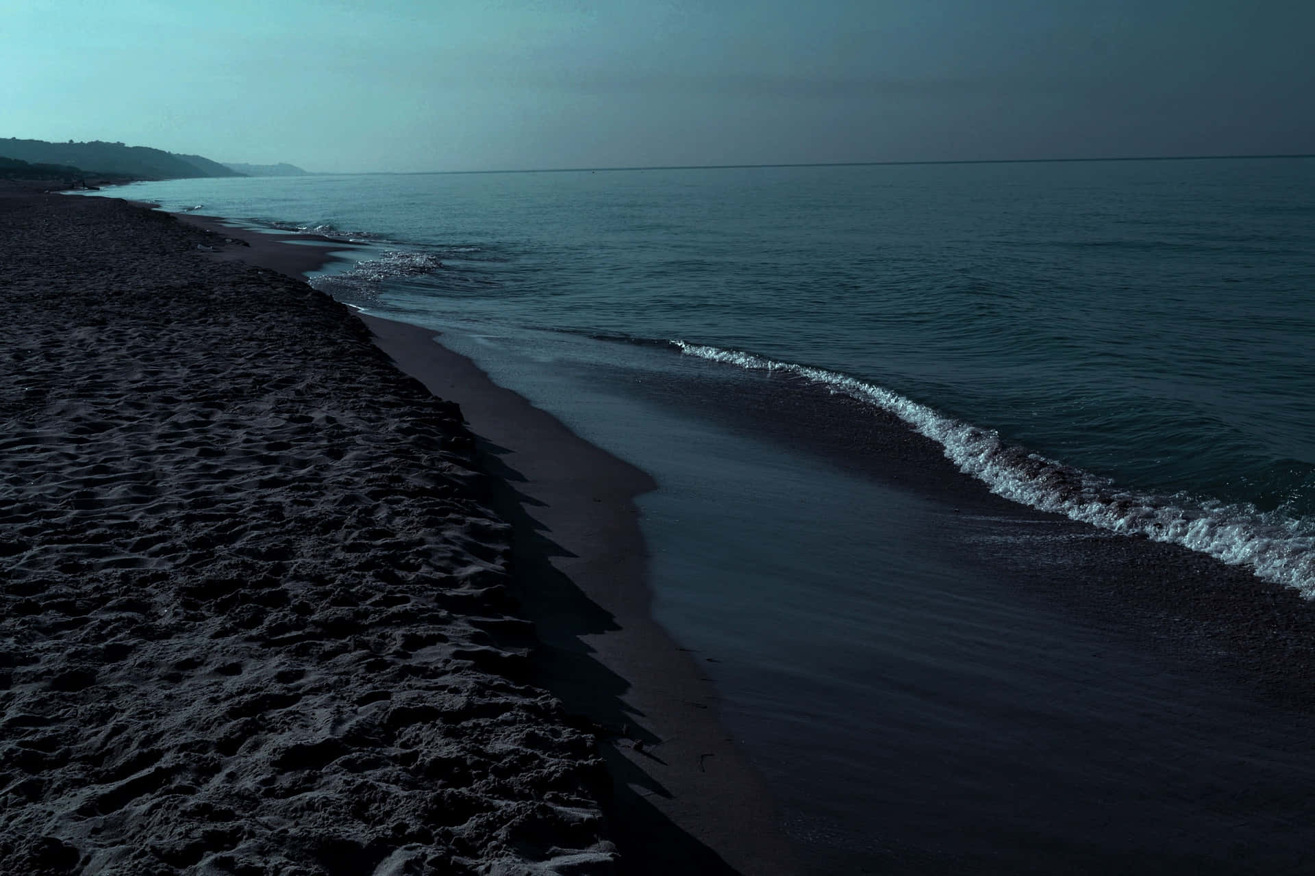 Soaking in the view of the mesmerizing Black Sand Beach. Wallpaper