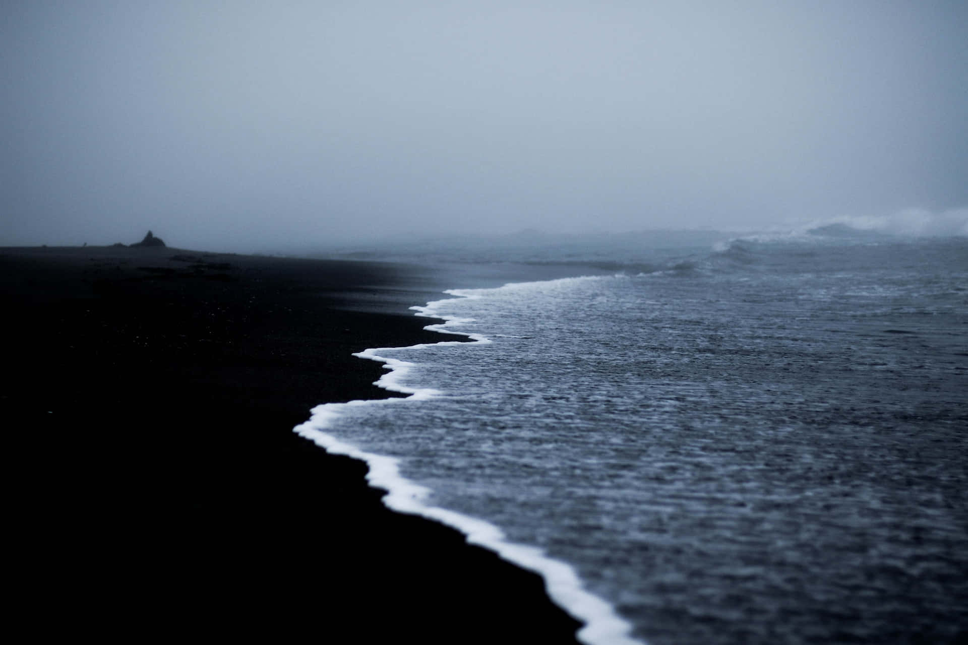 The calmness of black sand beach Wallpaper