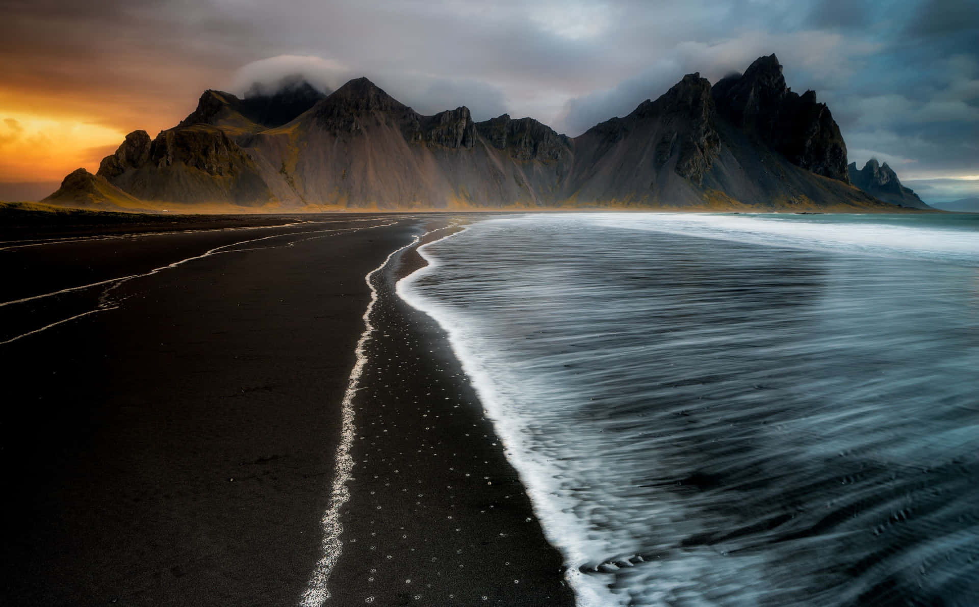 An idyllic black sand beach, paradise on earth. Wallpaper