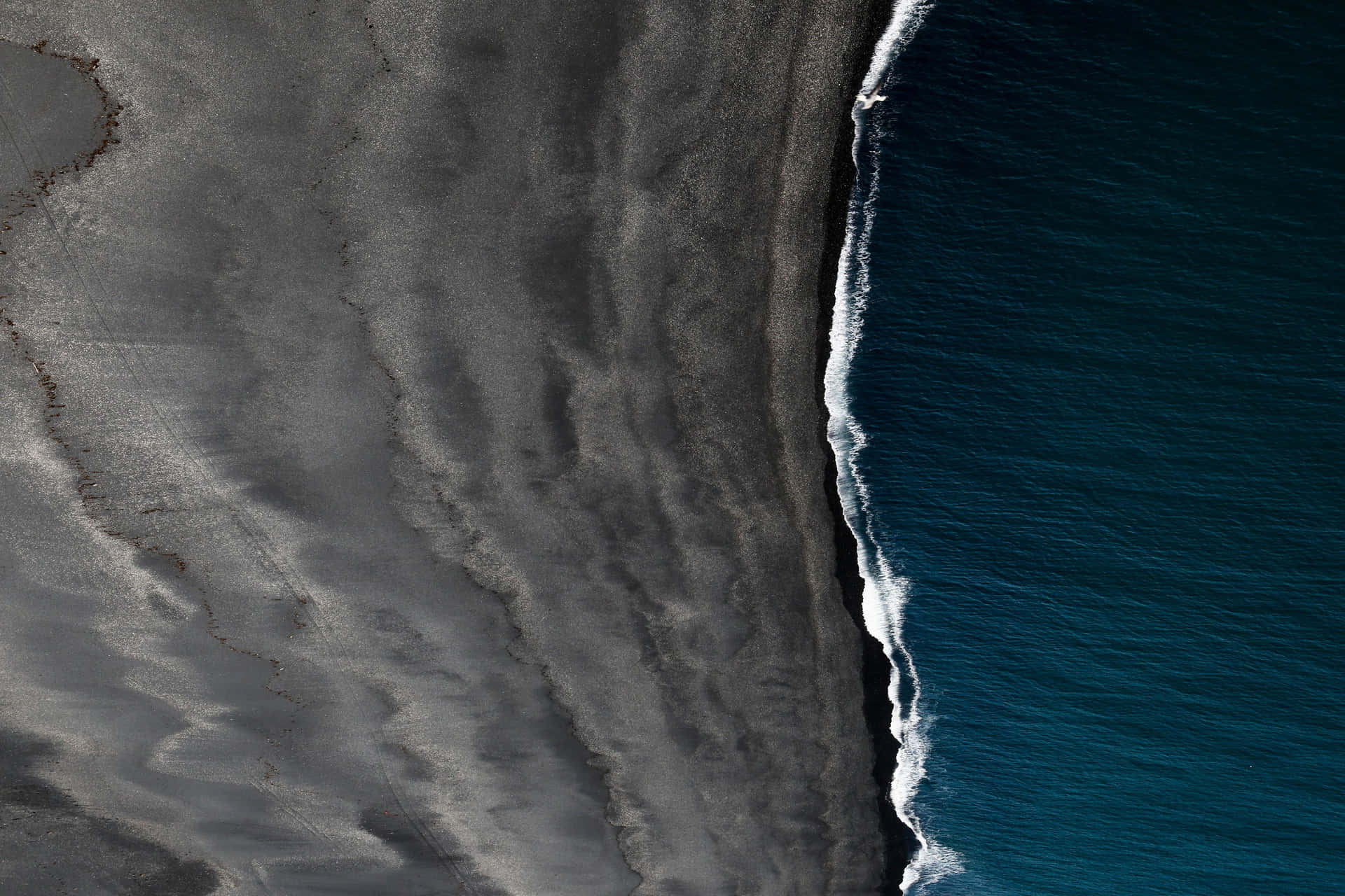 Revel in the majesty of a black sand beach. Wallpaper