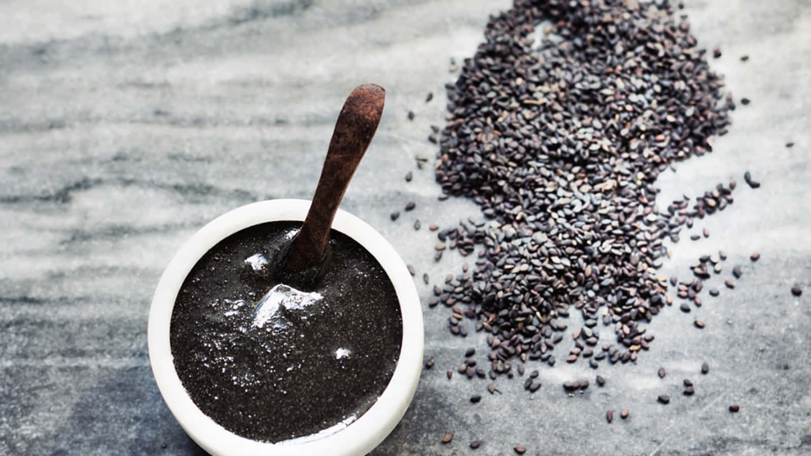 A close-up view of freshly ground black sesame seeds Wallpaper