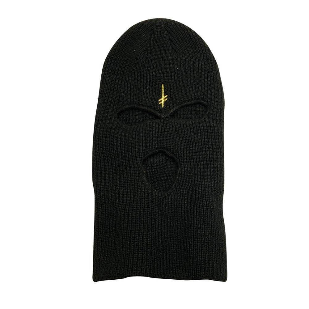 A Black Knit Mask With A Gold Logo Wallpaper