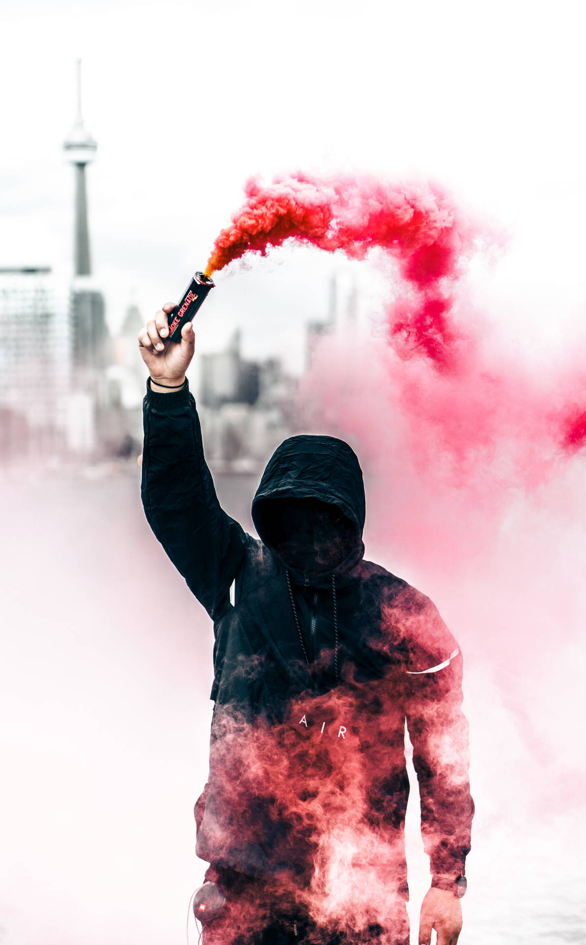 A Man Holding A Red Smoke Pipe Wallpaper