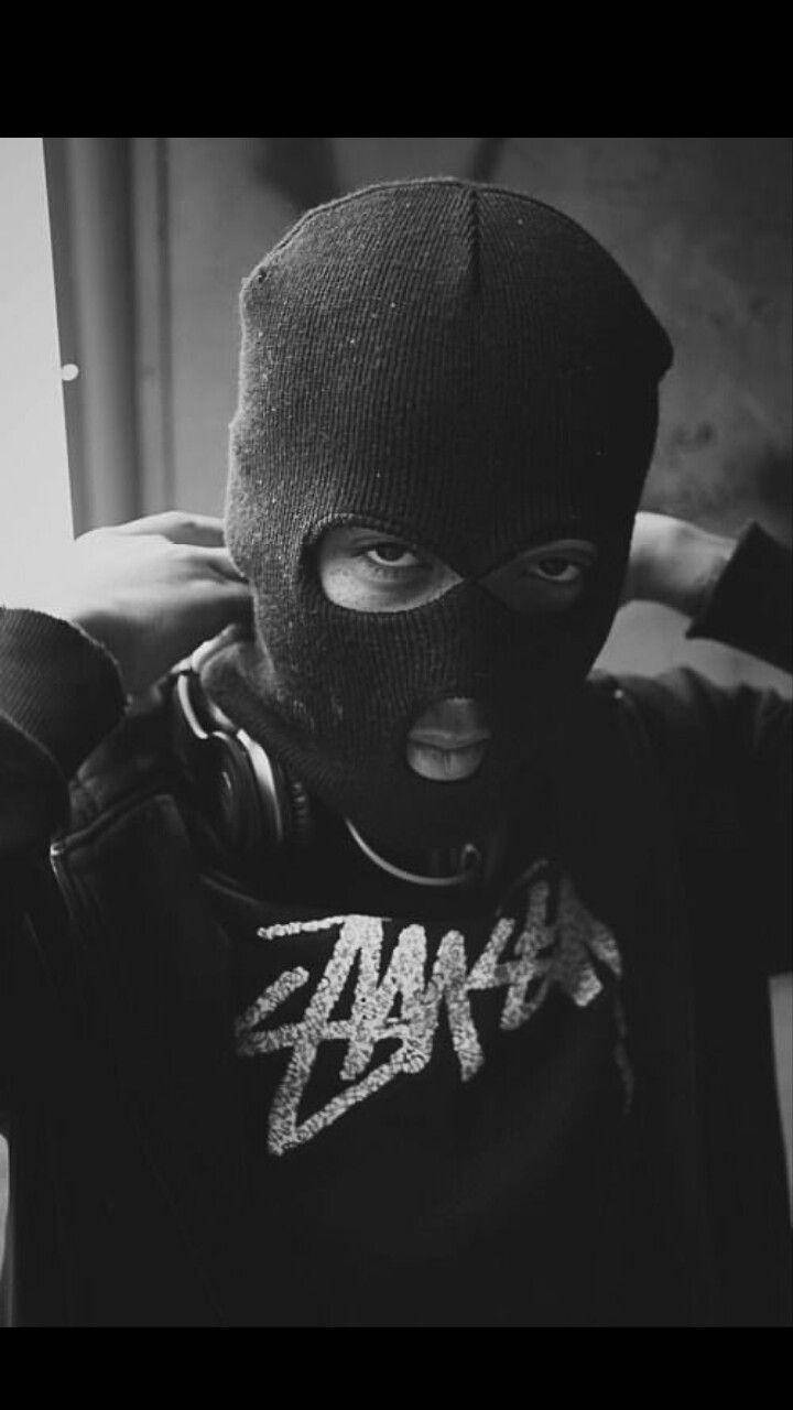 A Man In A Black Mask With Headphones Wallpaper