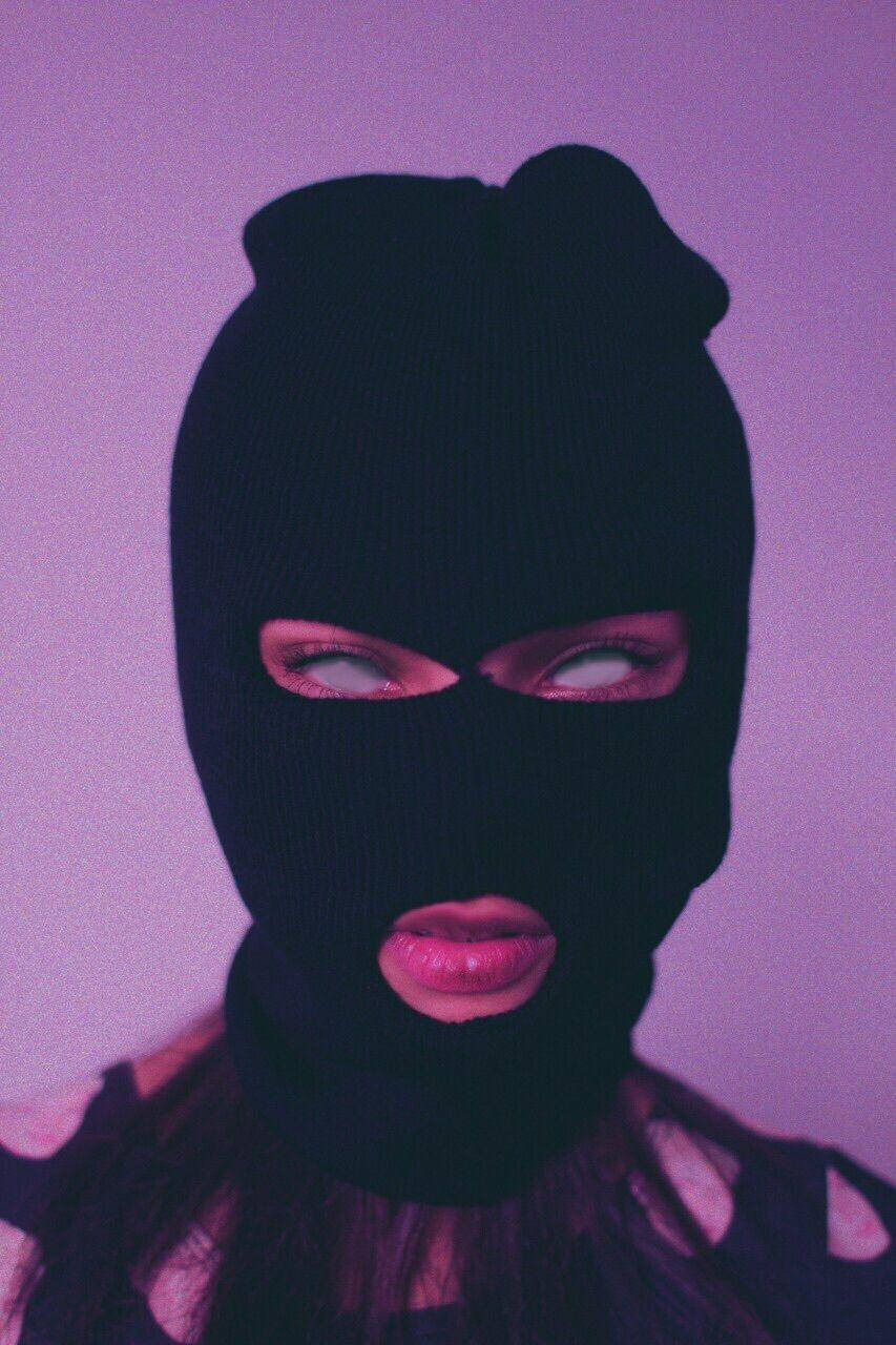 A Woman In A Knitted Mask With A Pink Dress Wallpaper
