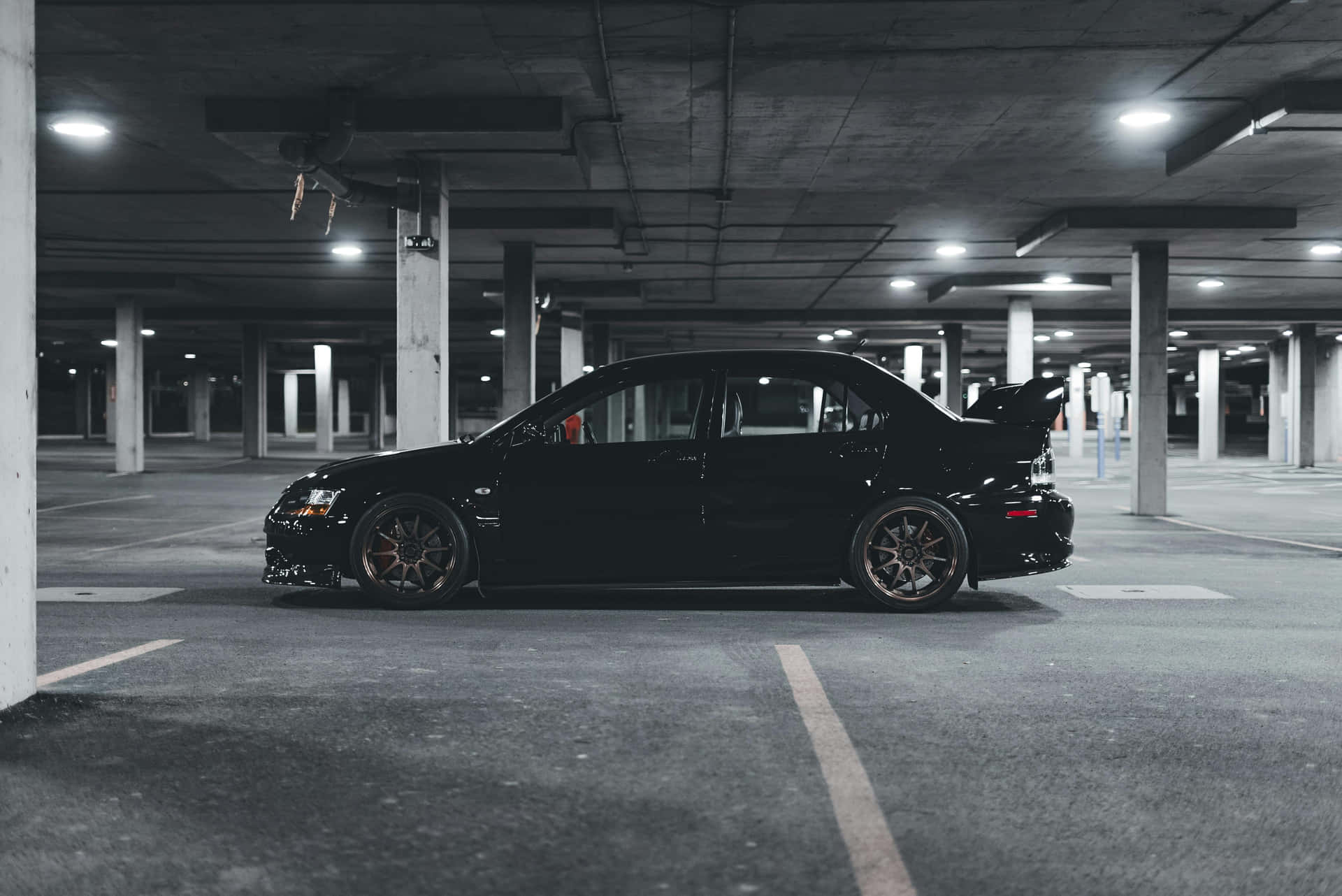Black Sports Car In Parking Garage Wallpaper