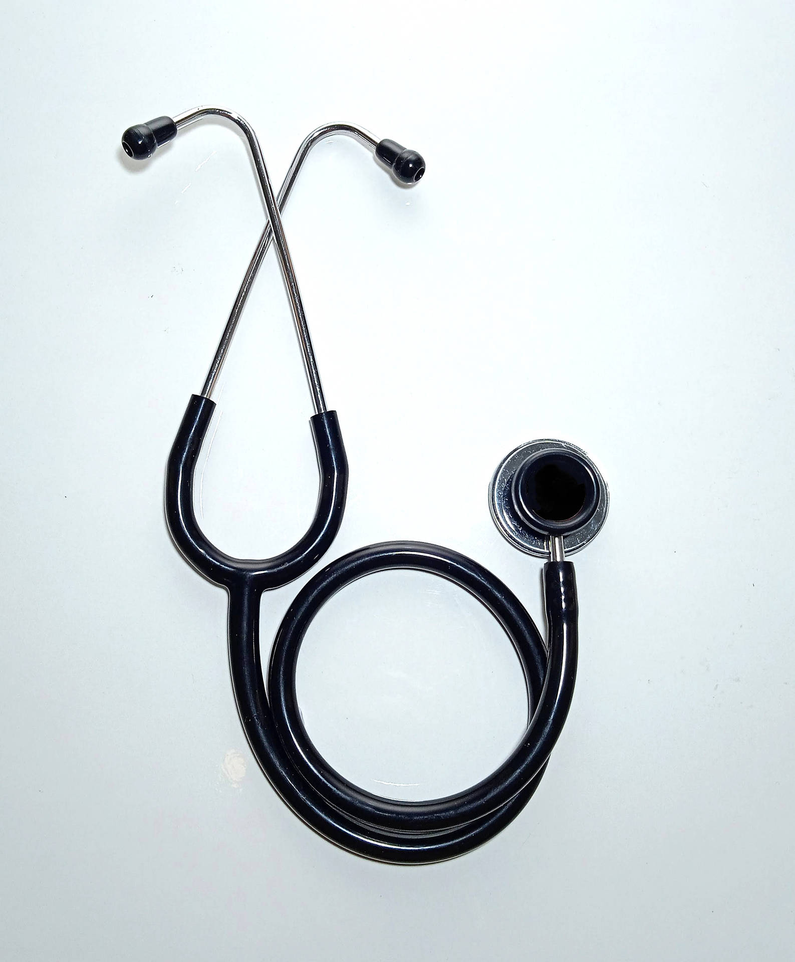 Stethoscope Is On A White Surface With A Black Coloured Strap Background,  Picture Of Medical Background Image And Wallpaper for Free Download
