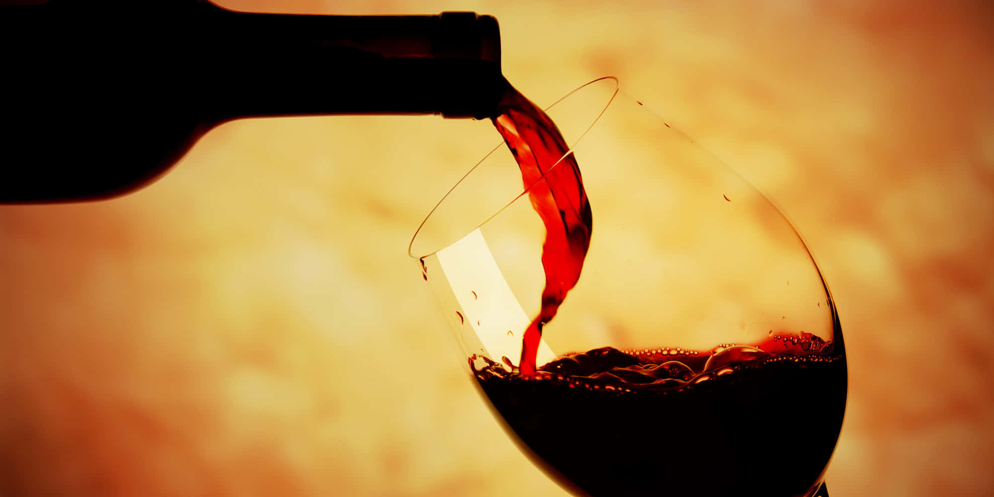 Image  A glass of black wine glistening in the light Wallpaper