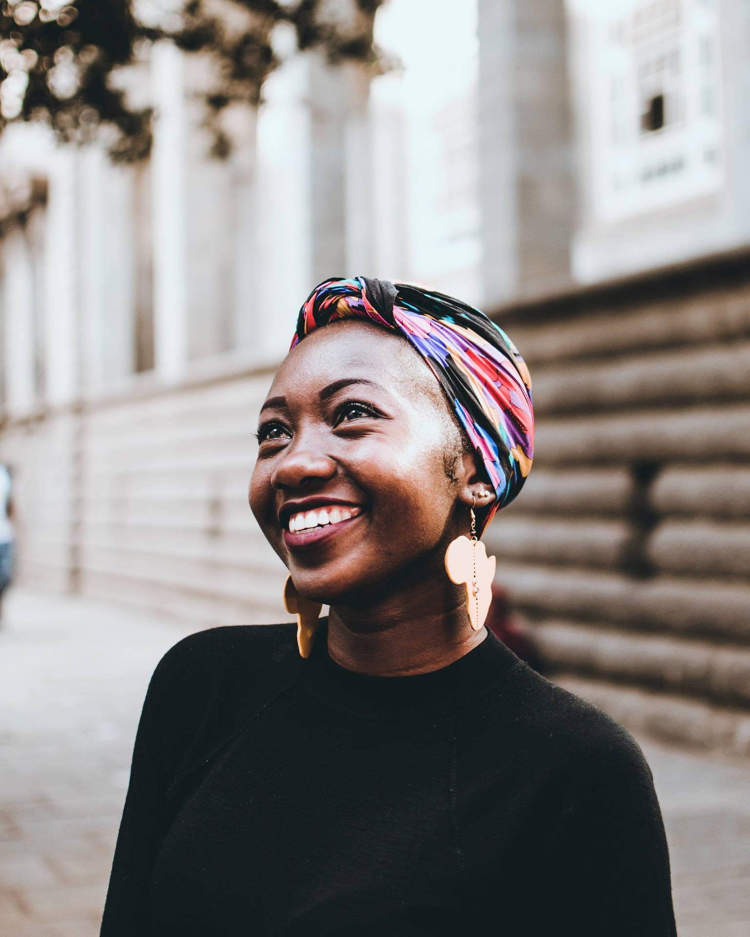 Empowered Black Woman with Vibrant Head Wrap Wallpaper
