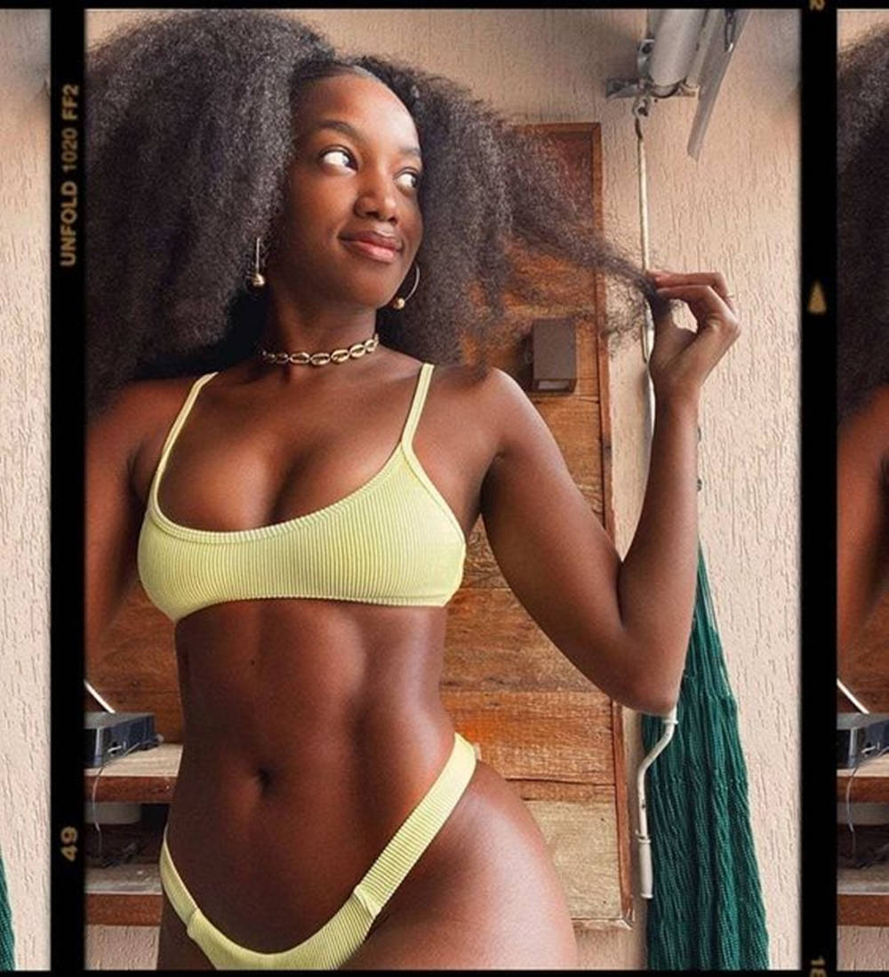 "Graceful black woman flaunting her curves in a stylish bikini" Wallpaper