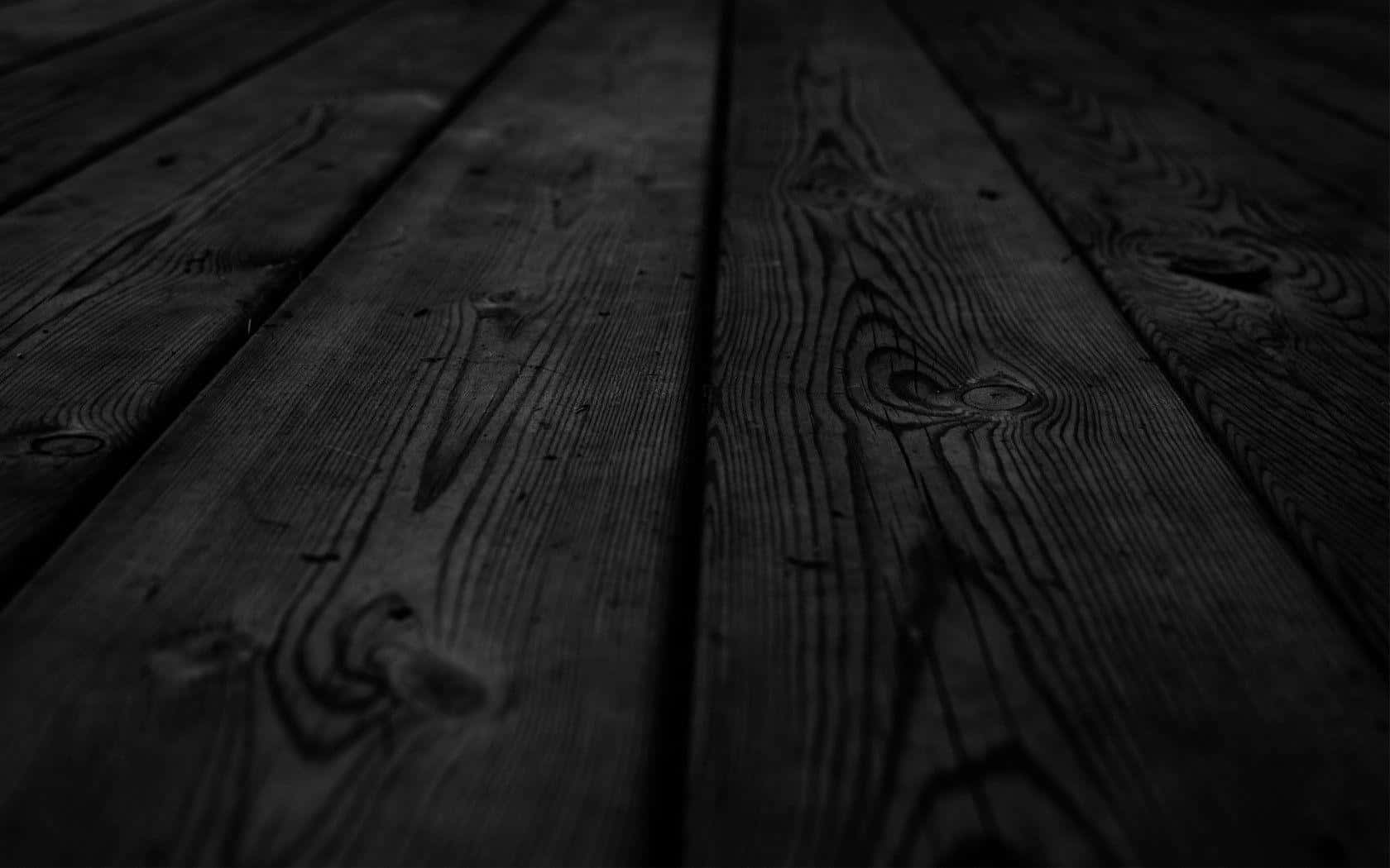 A Black And White Photo Of A Wooden Floor