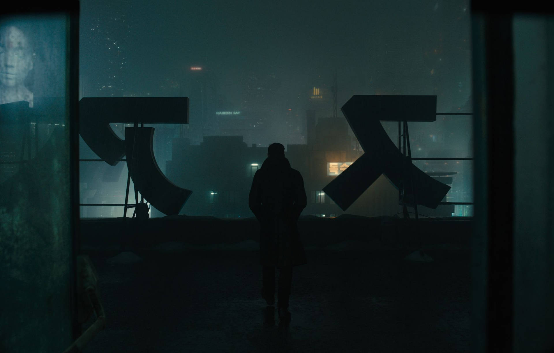 K searches the rooftop nightscape of Blade Runner 2049 Wallpaper