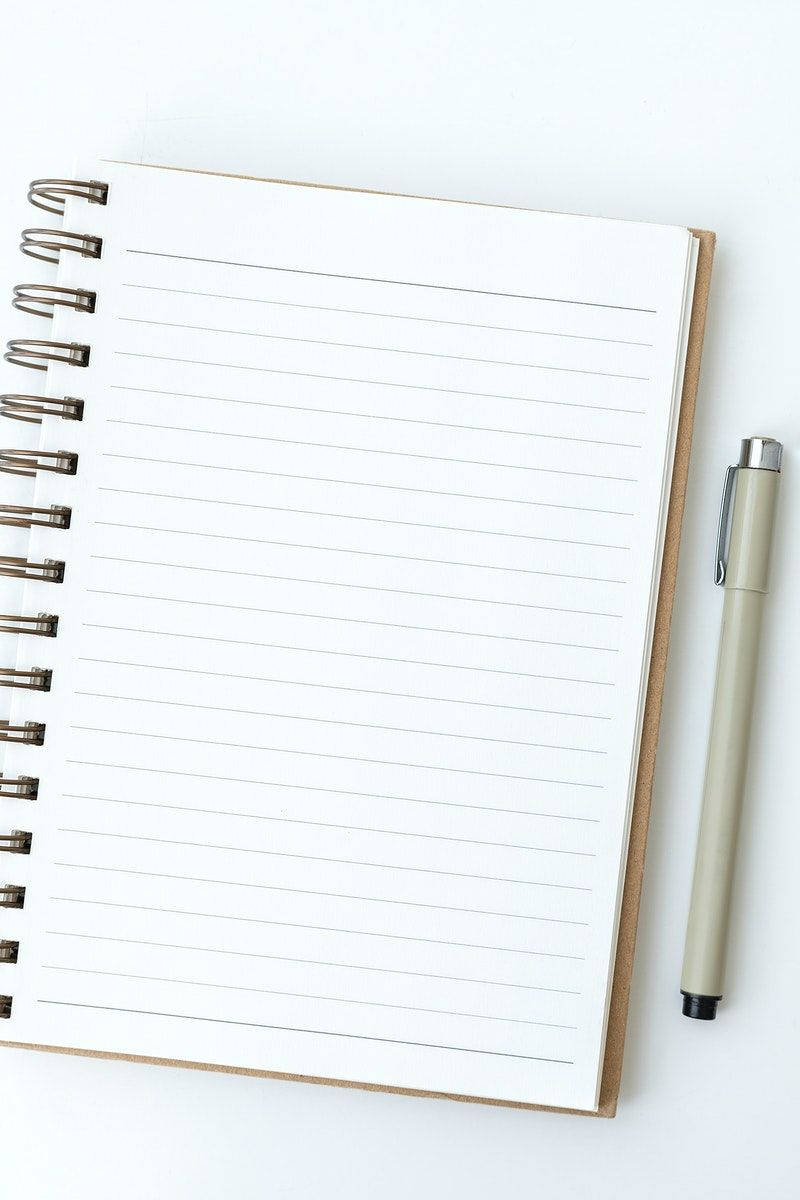 Blank notebook page with a ballpen Wallpaper