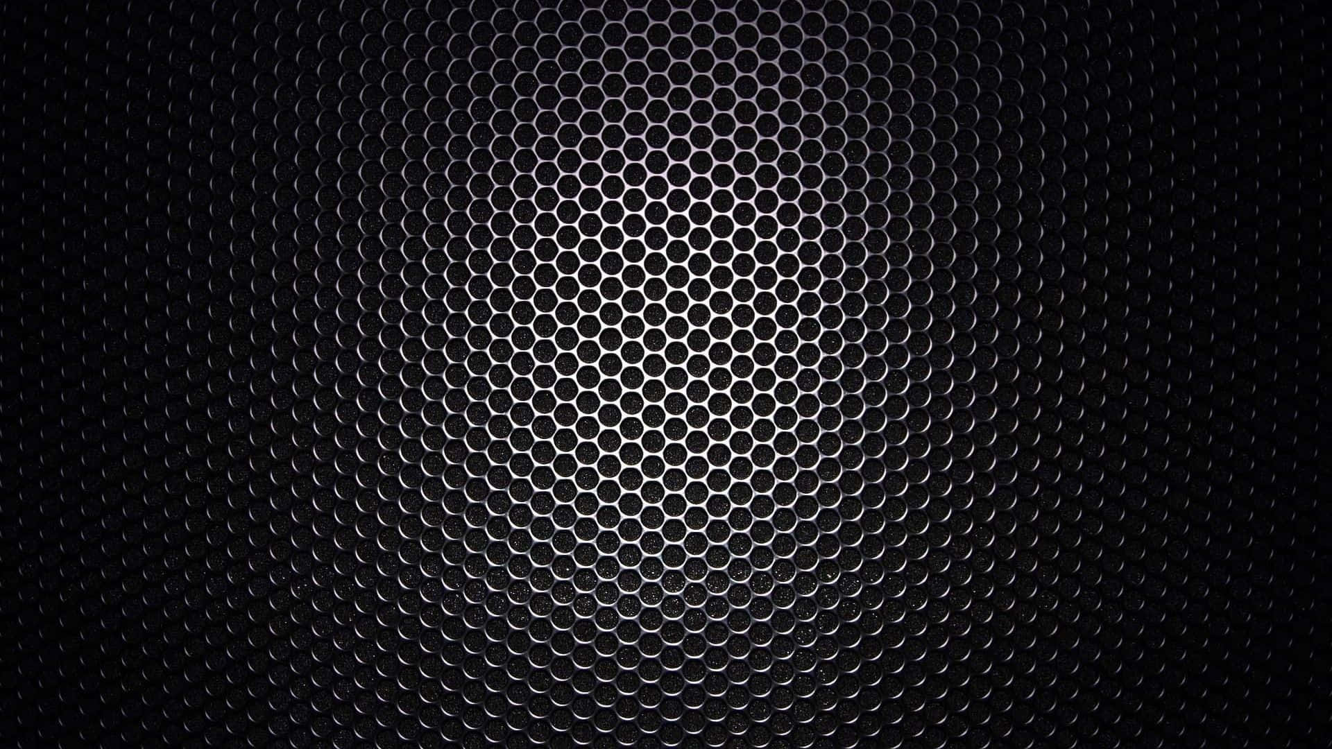 A Black Metal Background With A Pattern Of Holes