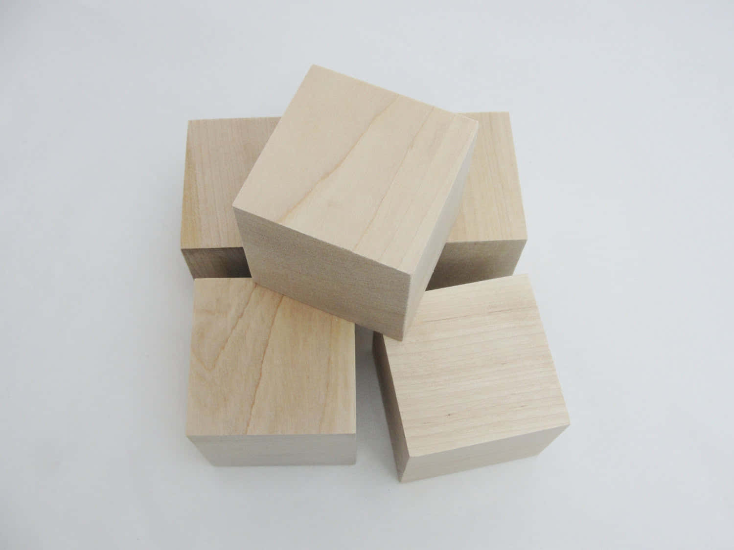 Four Wooden Cubes Stacked On Top Of Each Other