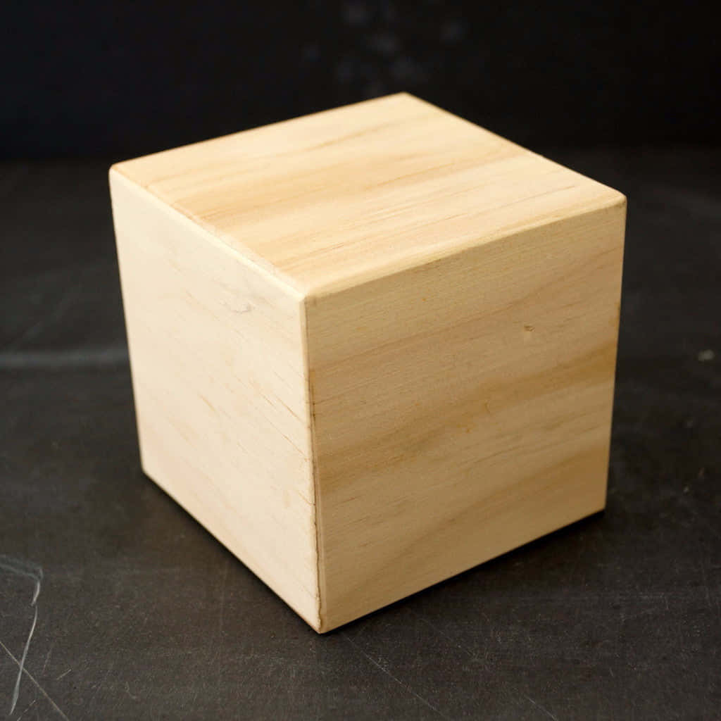 A Wooden Cube On A Black Surface