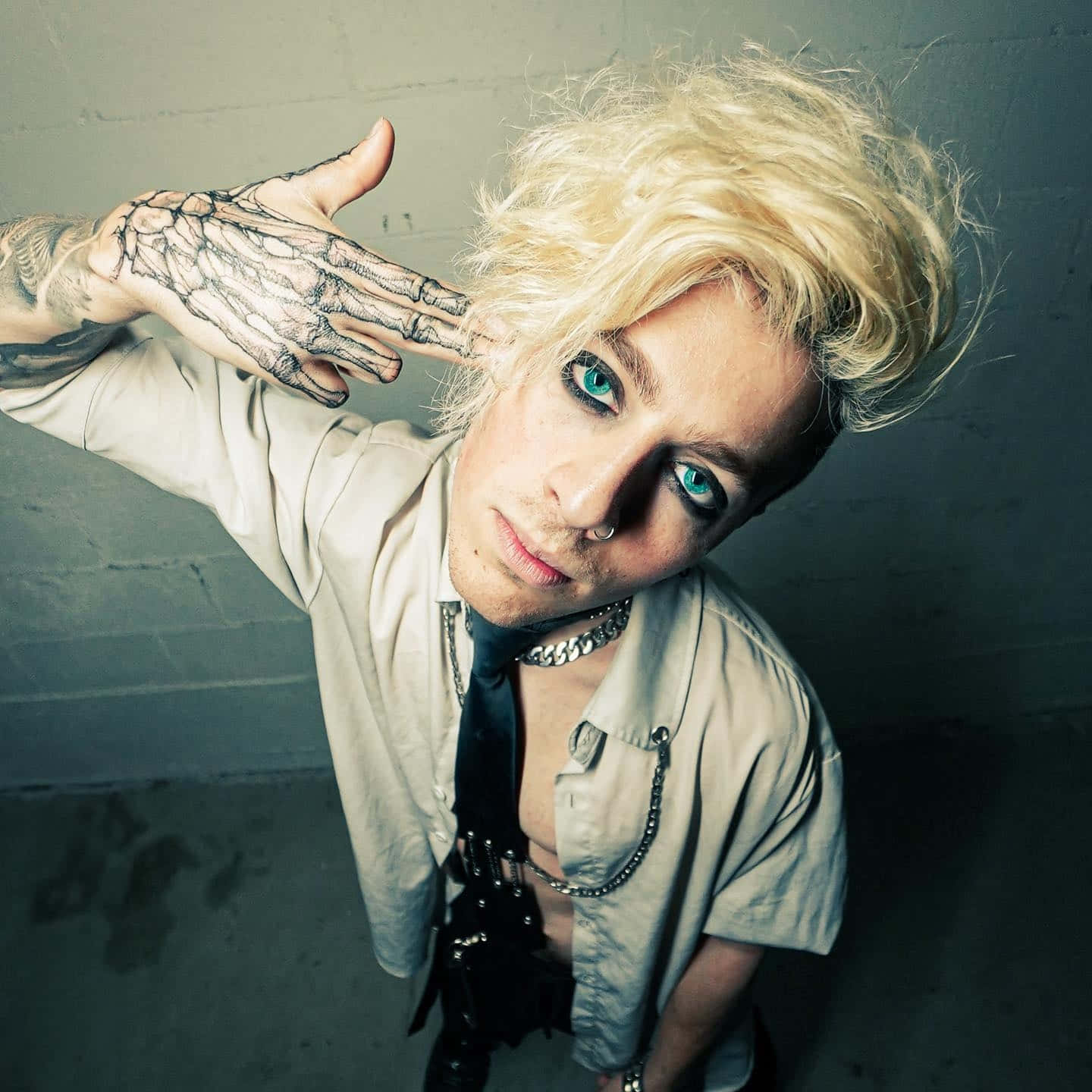 Blonde Haired Personwith Tattooed Hand Wallpaper