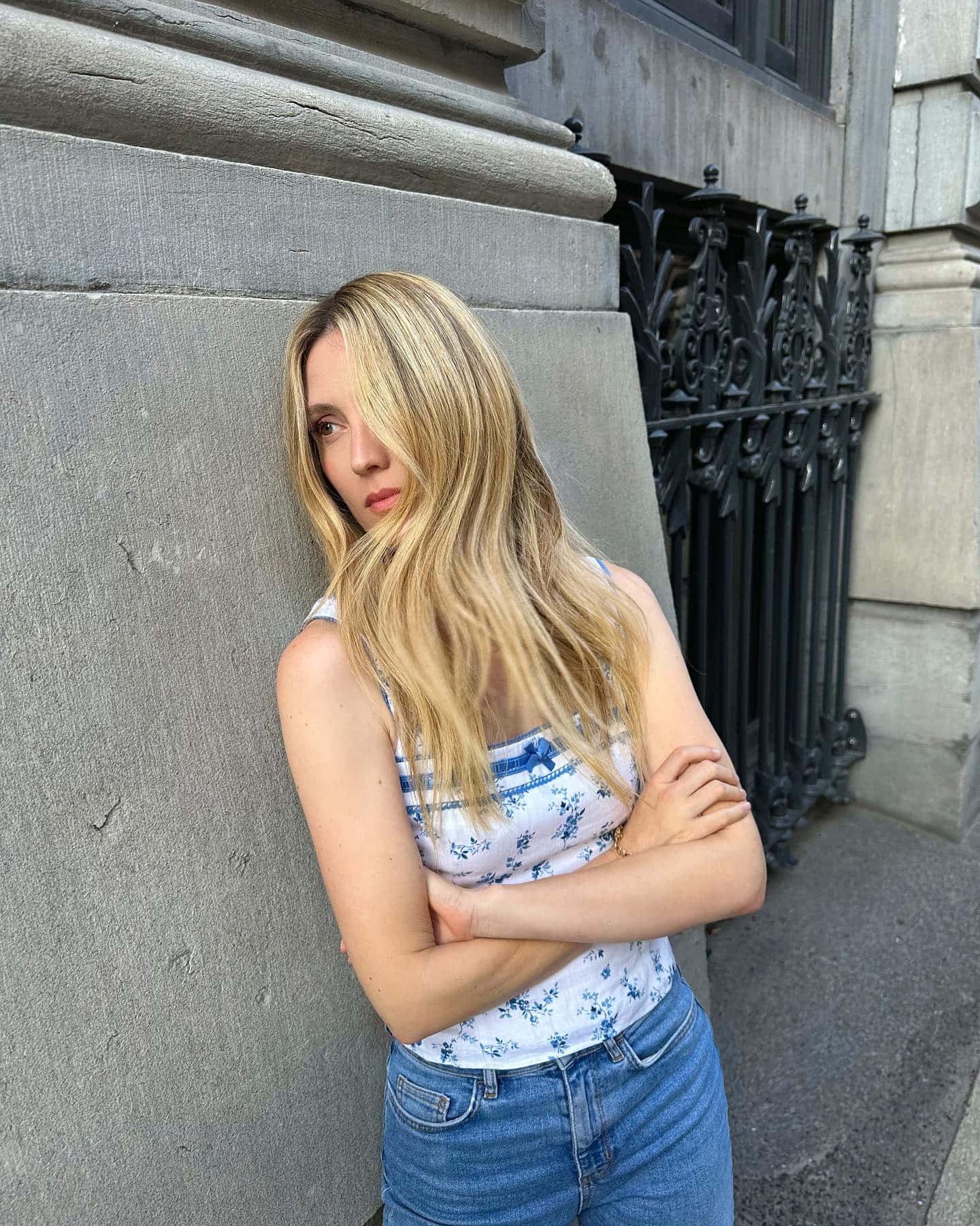 Blonde Woman Leaning Against Stone Wall Wallpaper