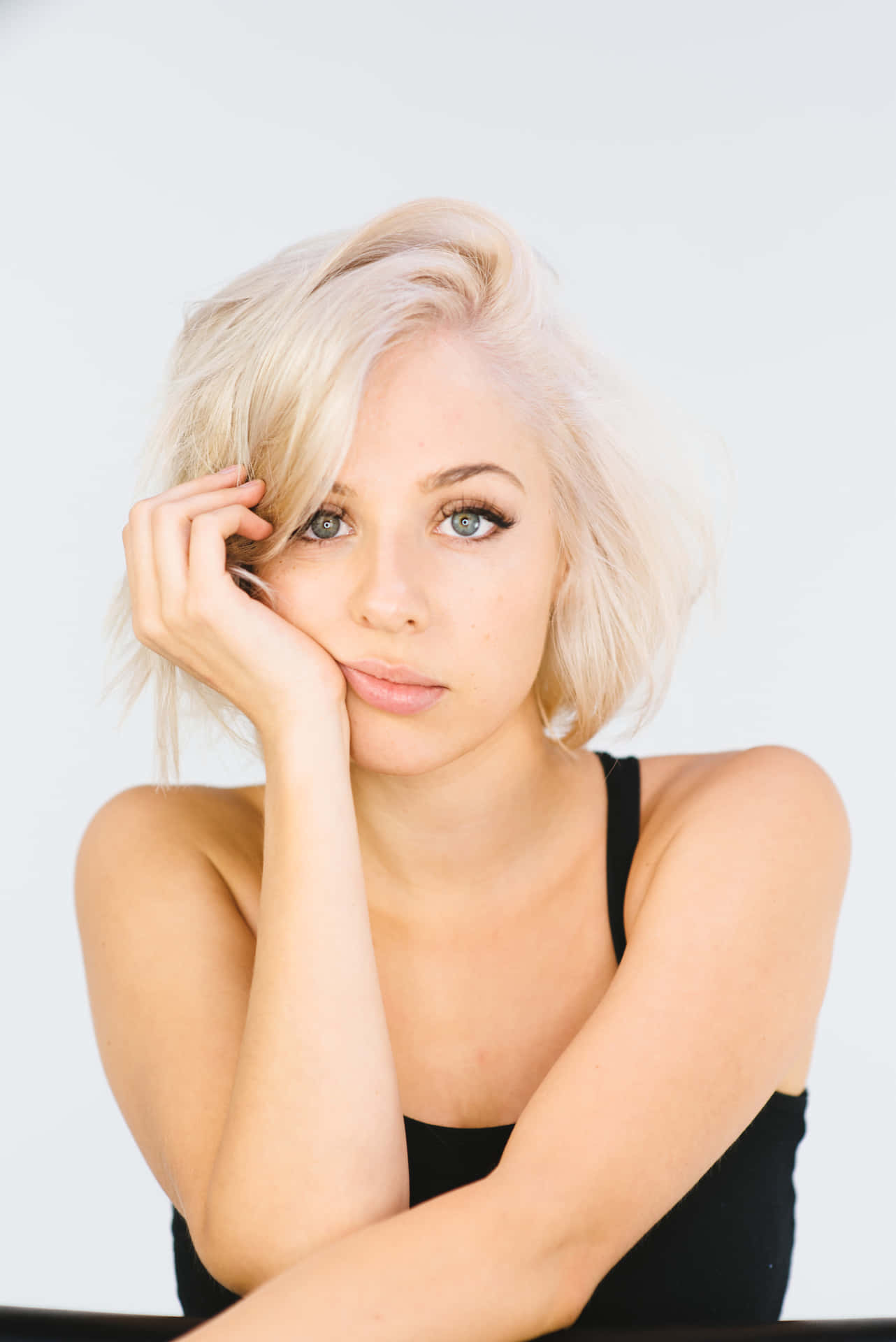 Blonde Woman Pensive Pose Wallpaper