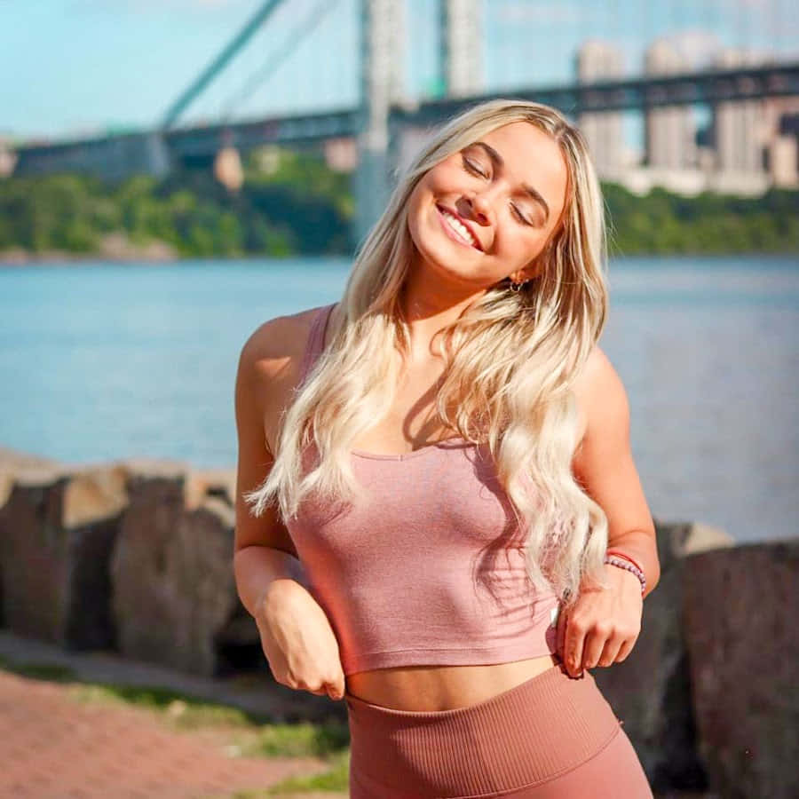 Blonde Woman Smiling Near Bridge Wallpaper
