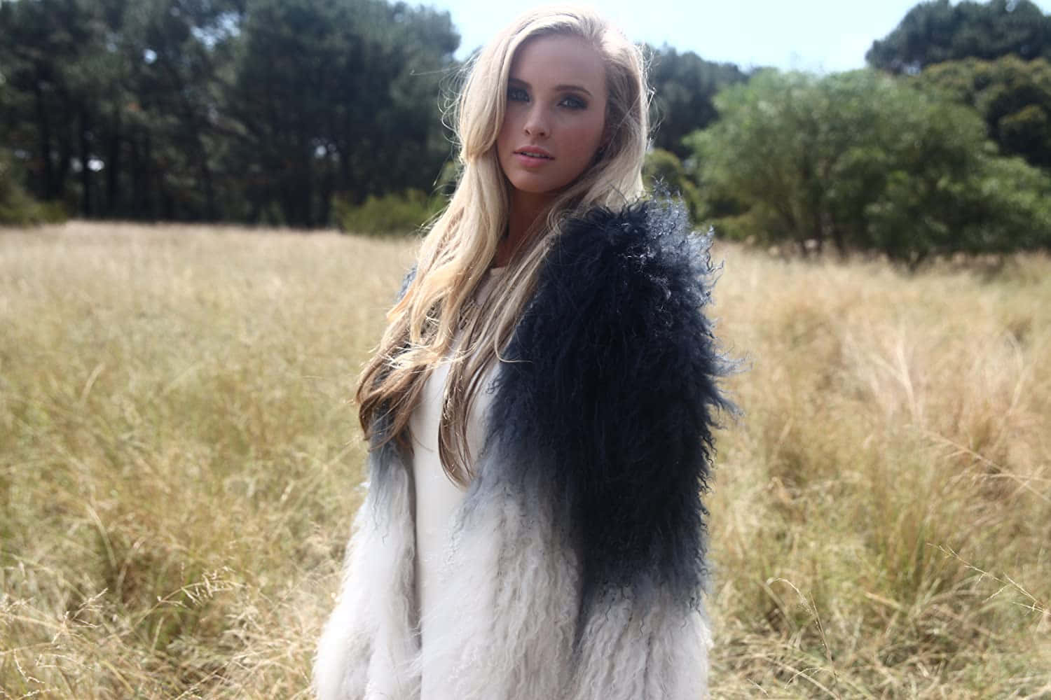 Blonde Womanin Fur Vest Outdoors Wallpaper