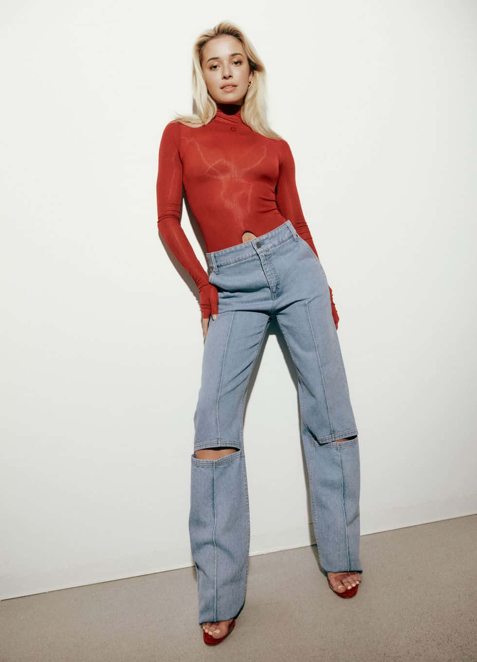 Blonde Womanin Red Turtleneckand Jeans Wallpaper
