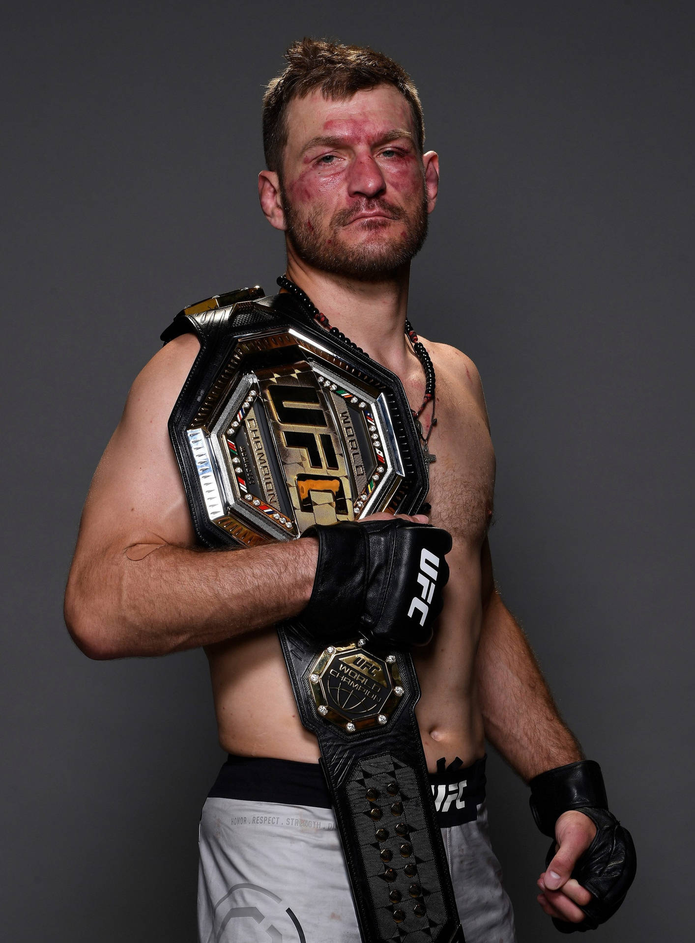 Stipe Miocic - Bloodied yet victorious, showcasing his championship belt Wallpaper