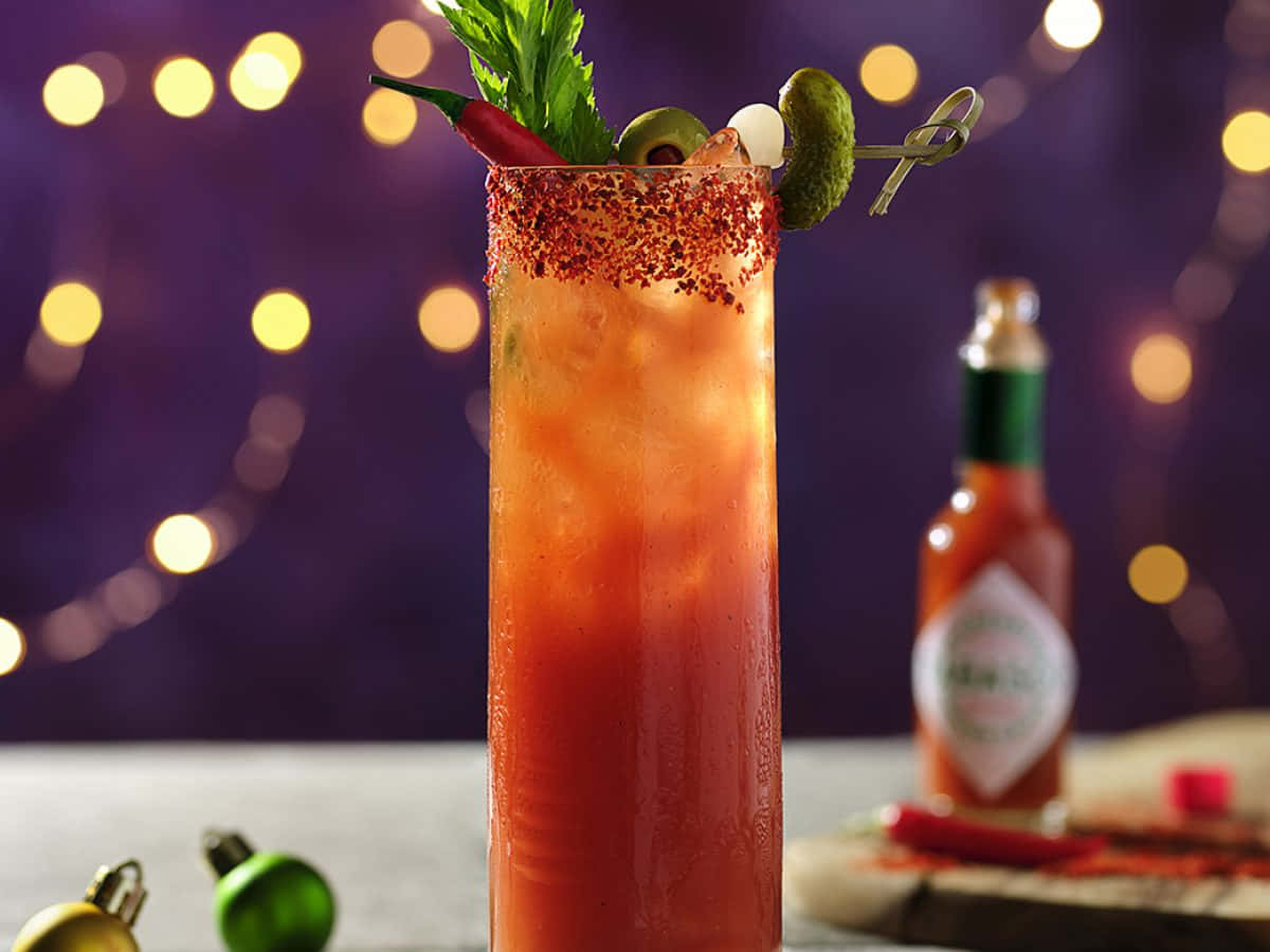Spicy Bloody Mary cocktail garnished with crisp jalapenos. Wallpaper