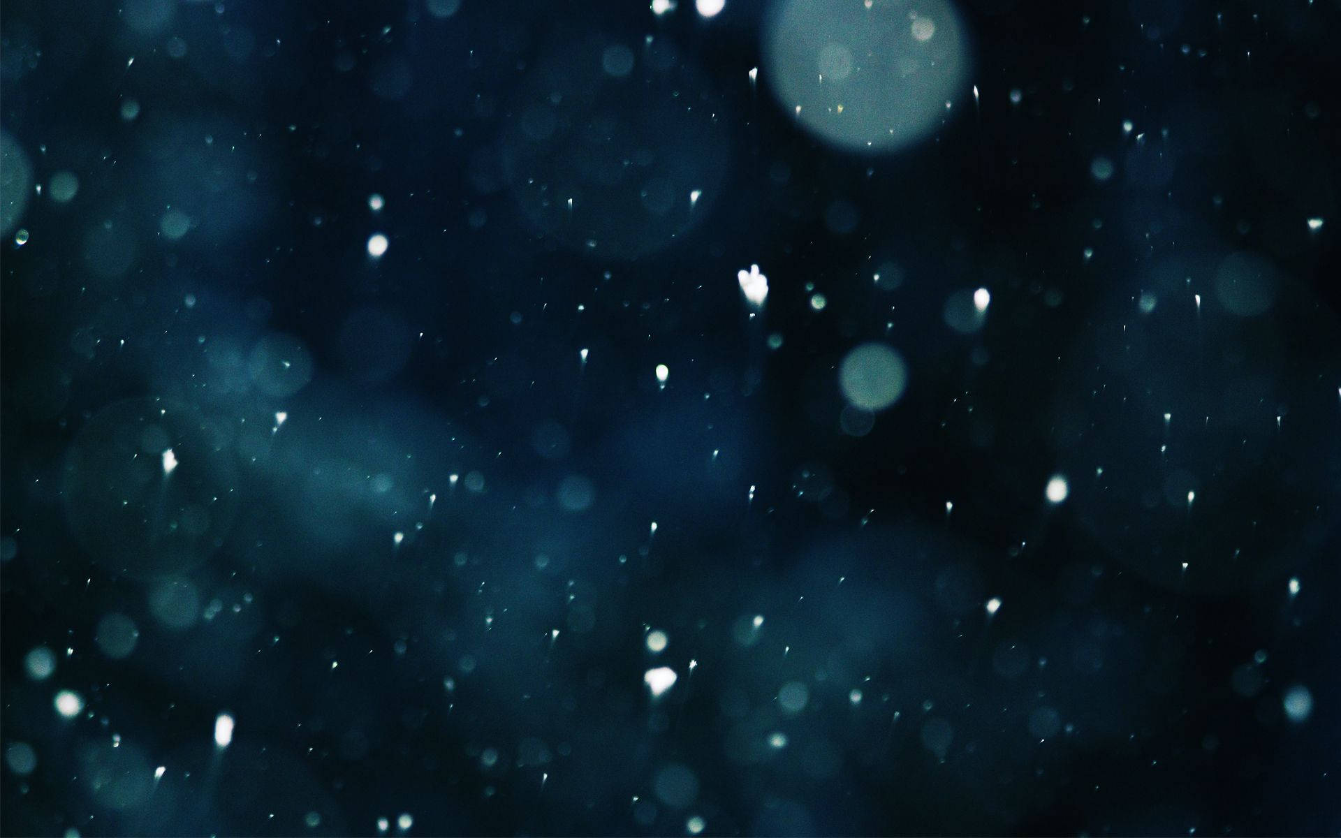 Snow Falling On A Dark Background Wallpaper