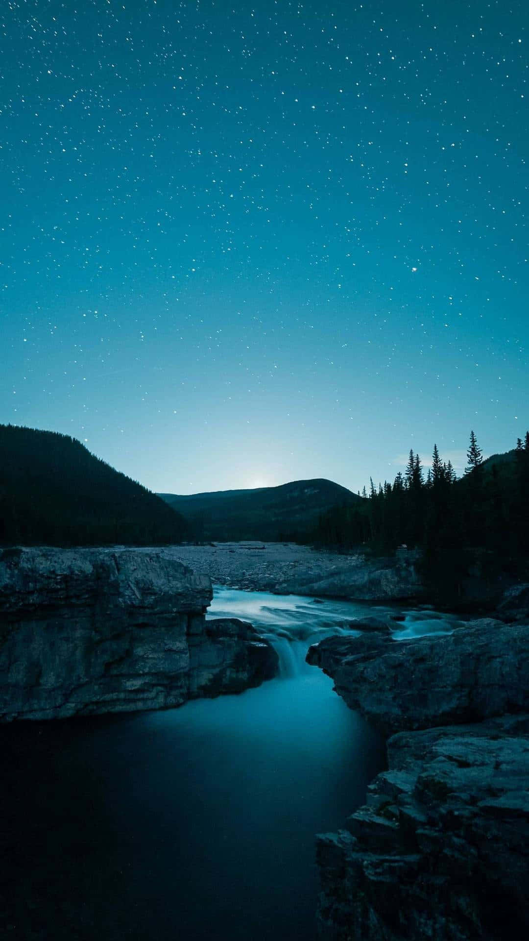 A River And Stars Under A Dark Sky Wallpaper