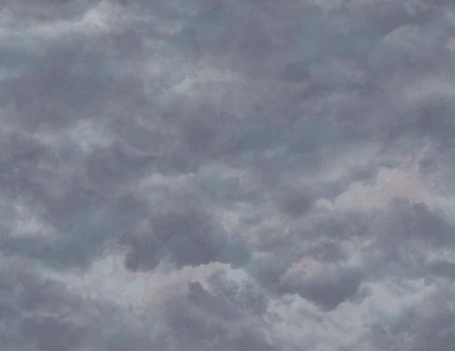 A Gray Sky With Clouds And A Few Clouds Wallpaper