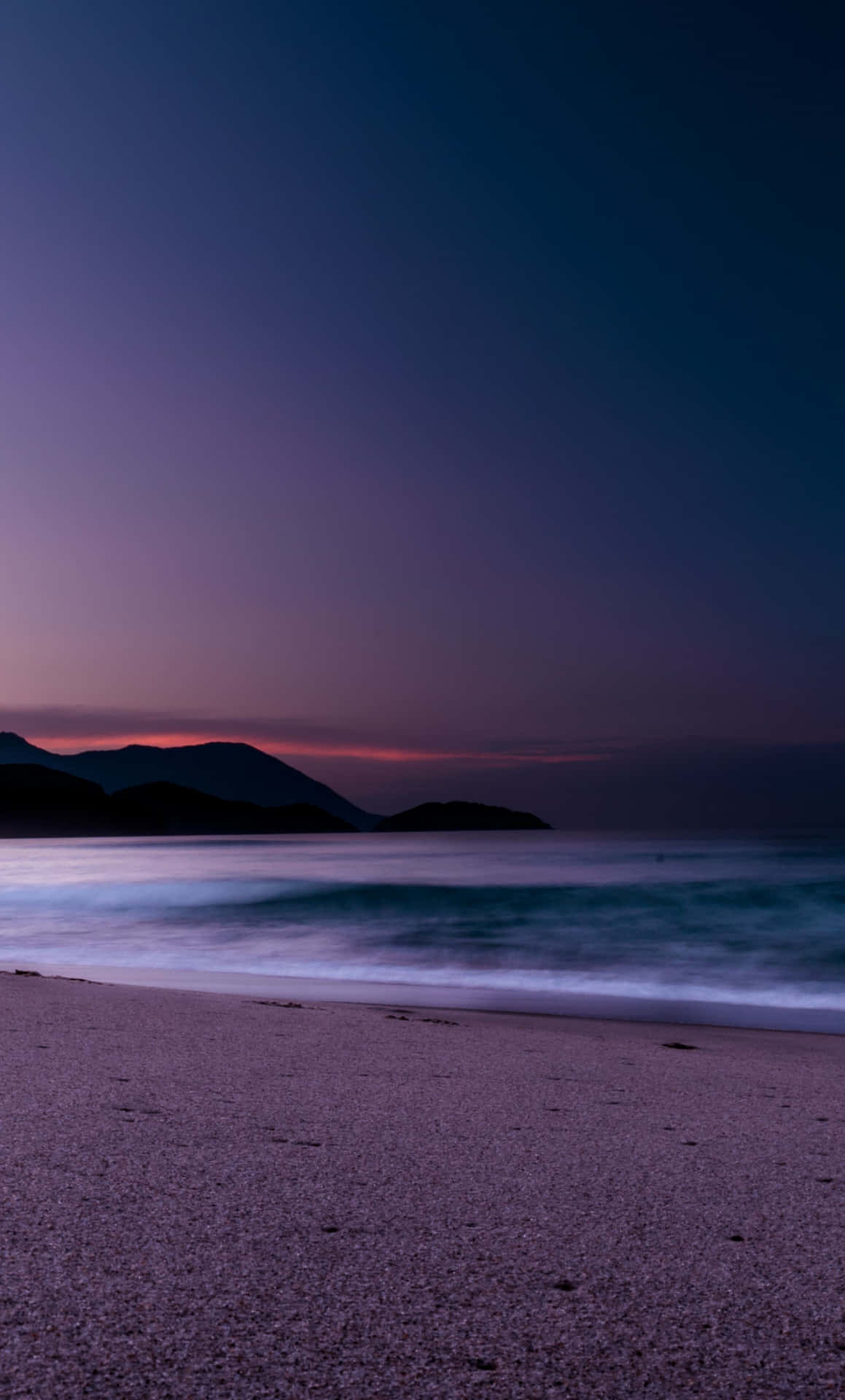 Download Waves On The Shore On Blue And Purple Sunset Wallpaper