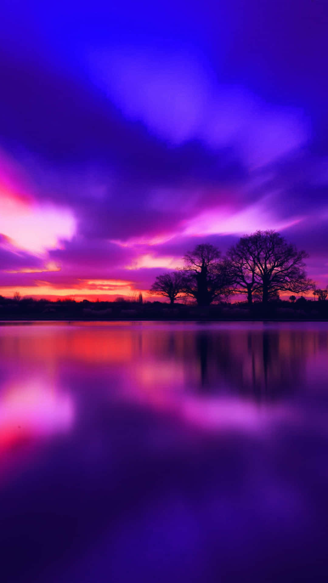 Enjoy the breathtaking view of a blue and purple sunset. Wallpaper