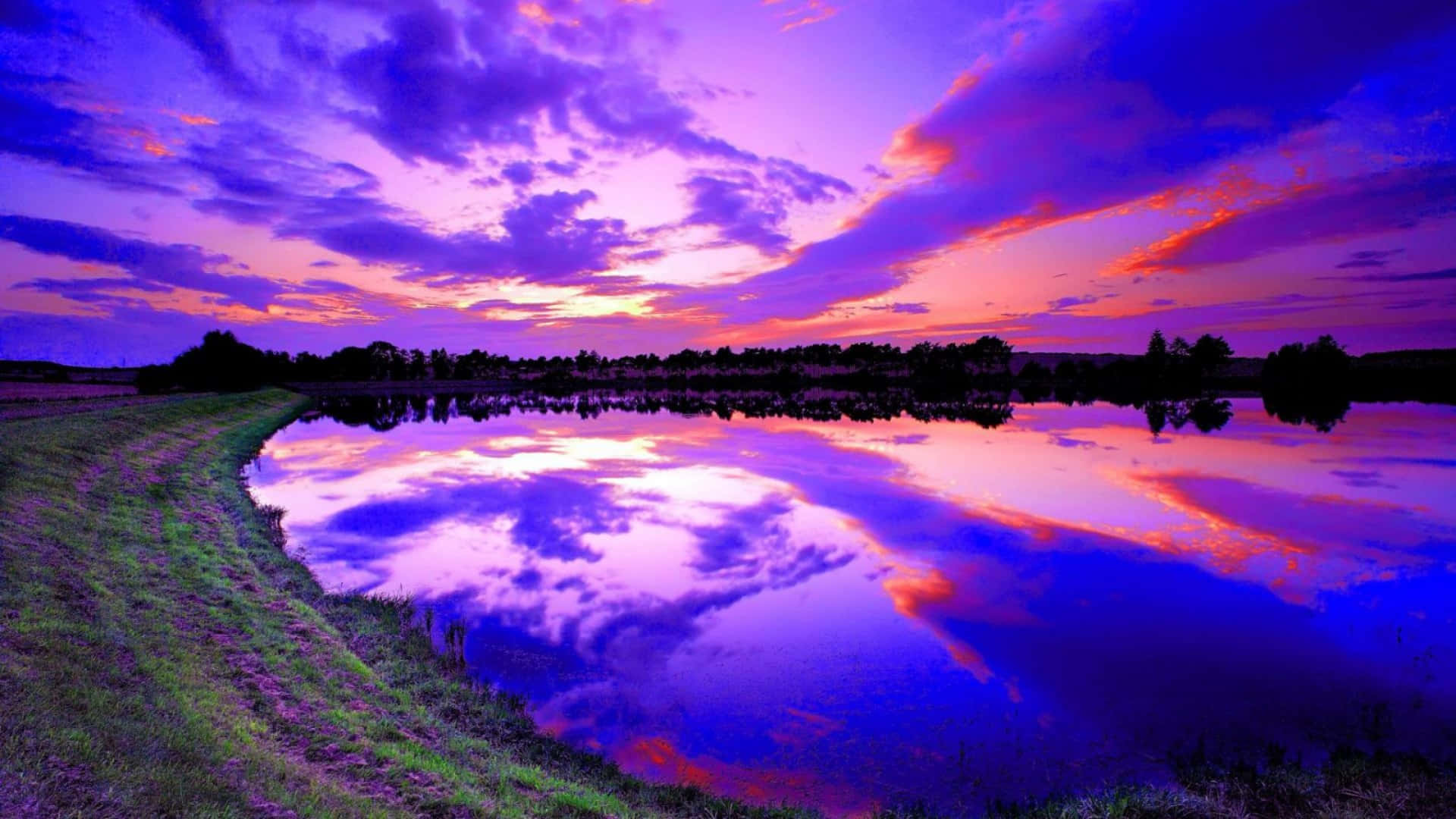 Vast Lake With A Blue And Purple Sunset Wallpaper