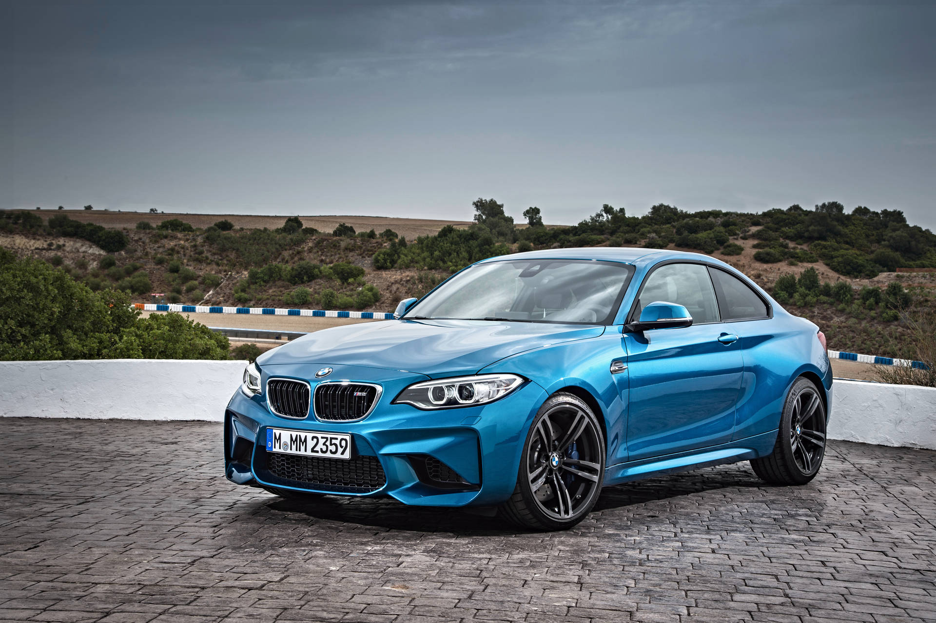 Cruise along the mountain roads in a Blue BMW F87 Wallpaper