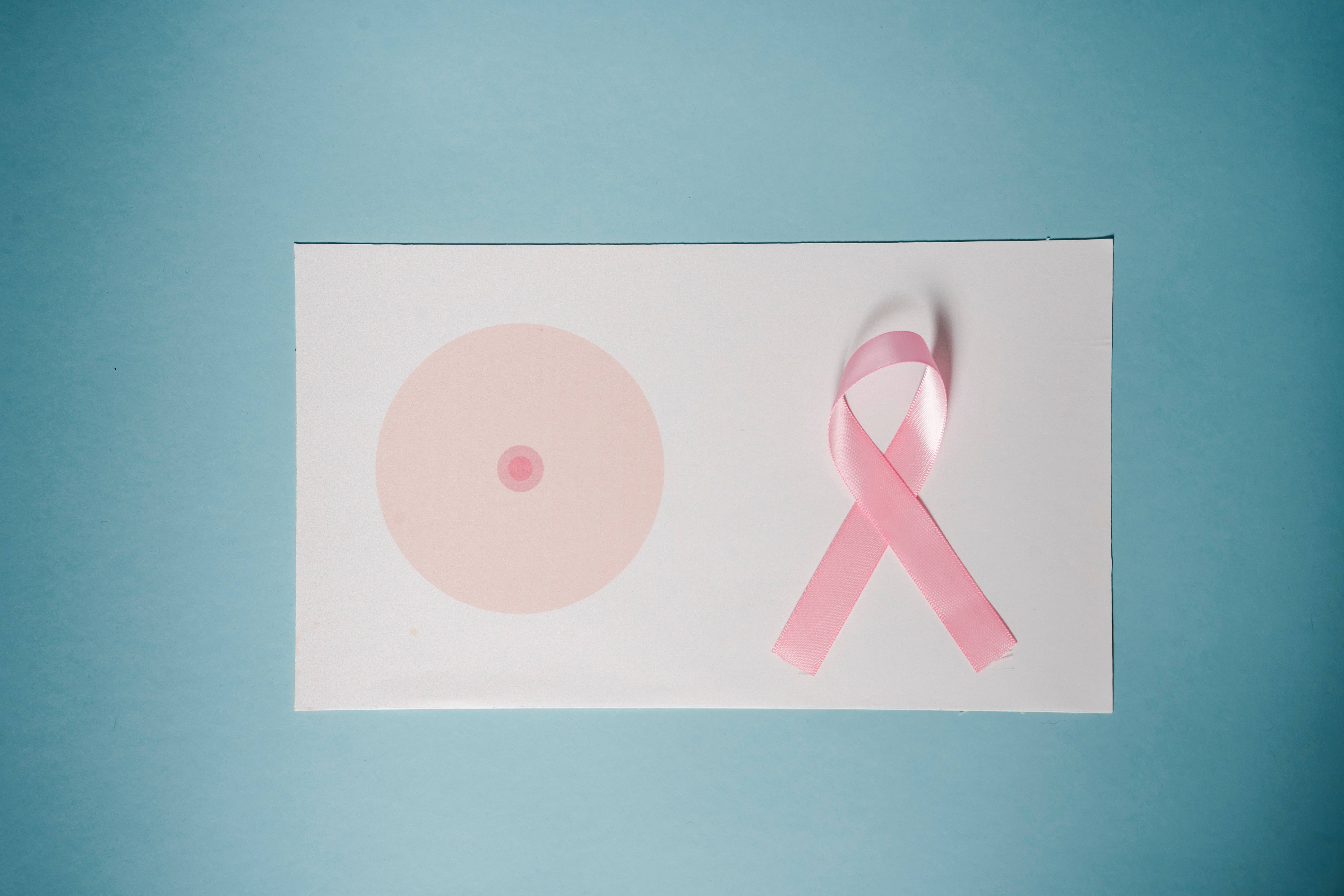 Blå kræft Awareness bånd mod en let pastel rosa baggrund. Wallpaper