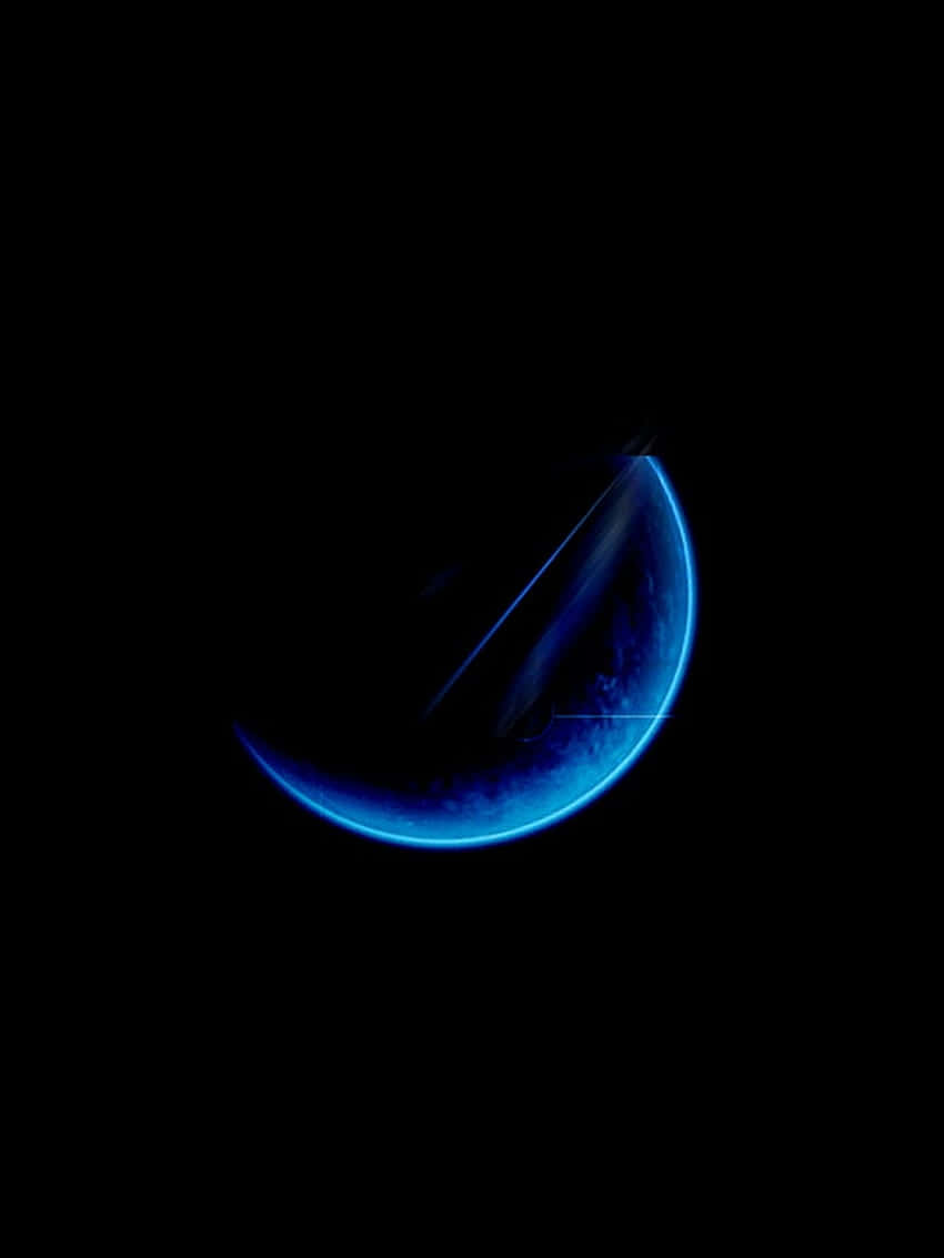 Blue Crescent Moon Against Black Sky Wallpaper