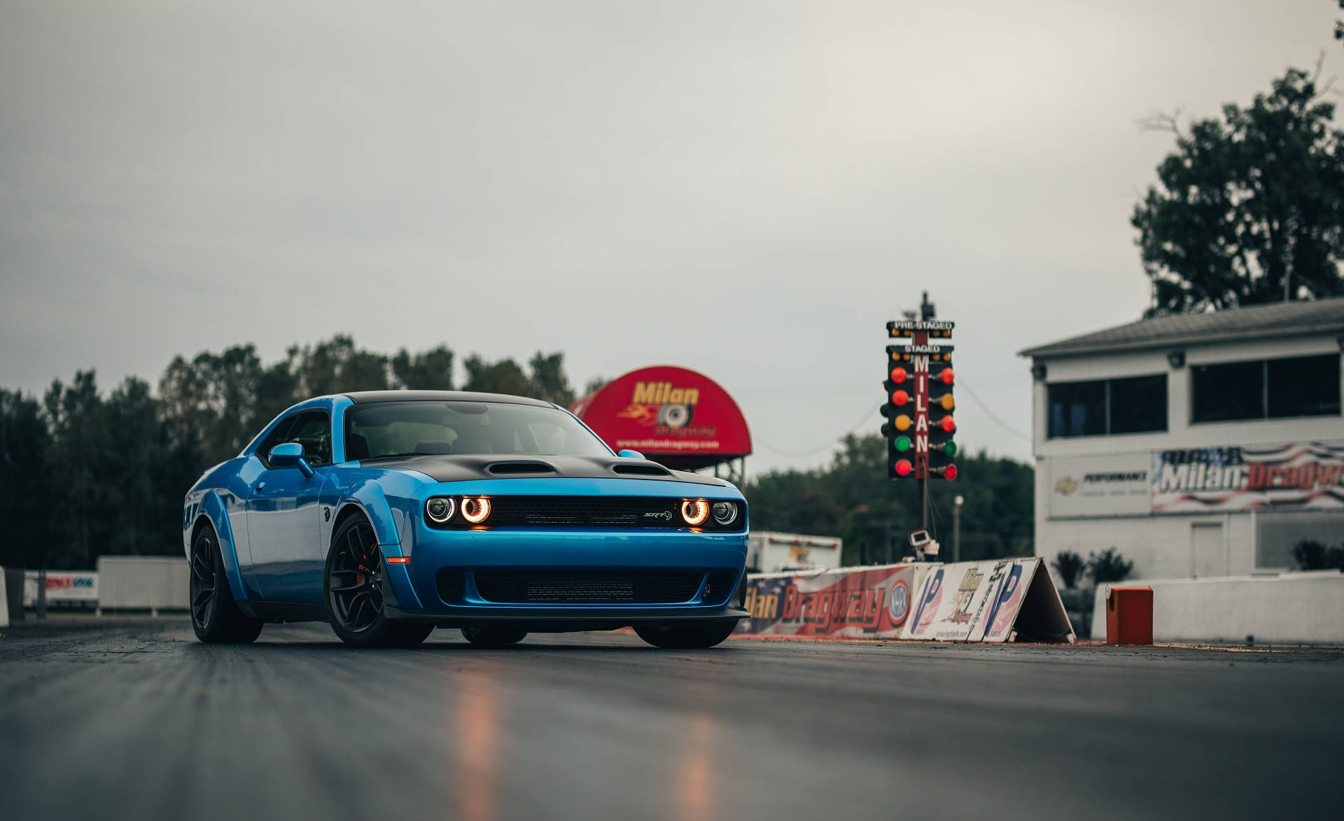 Blue Dodge Challenger In A Race Track Background