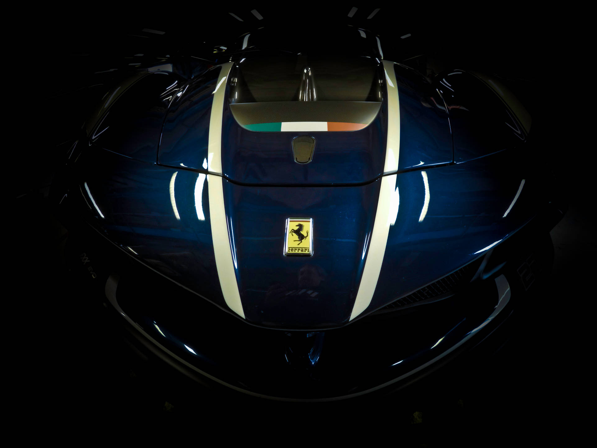 Blue Ferrari sports car with light reflections top view wallpaper.