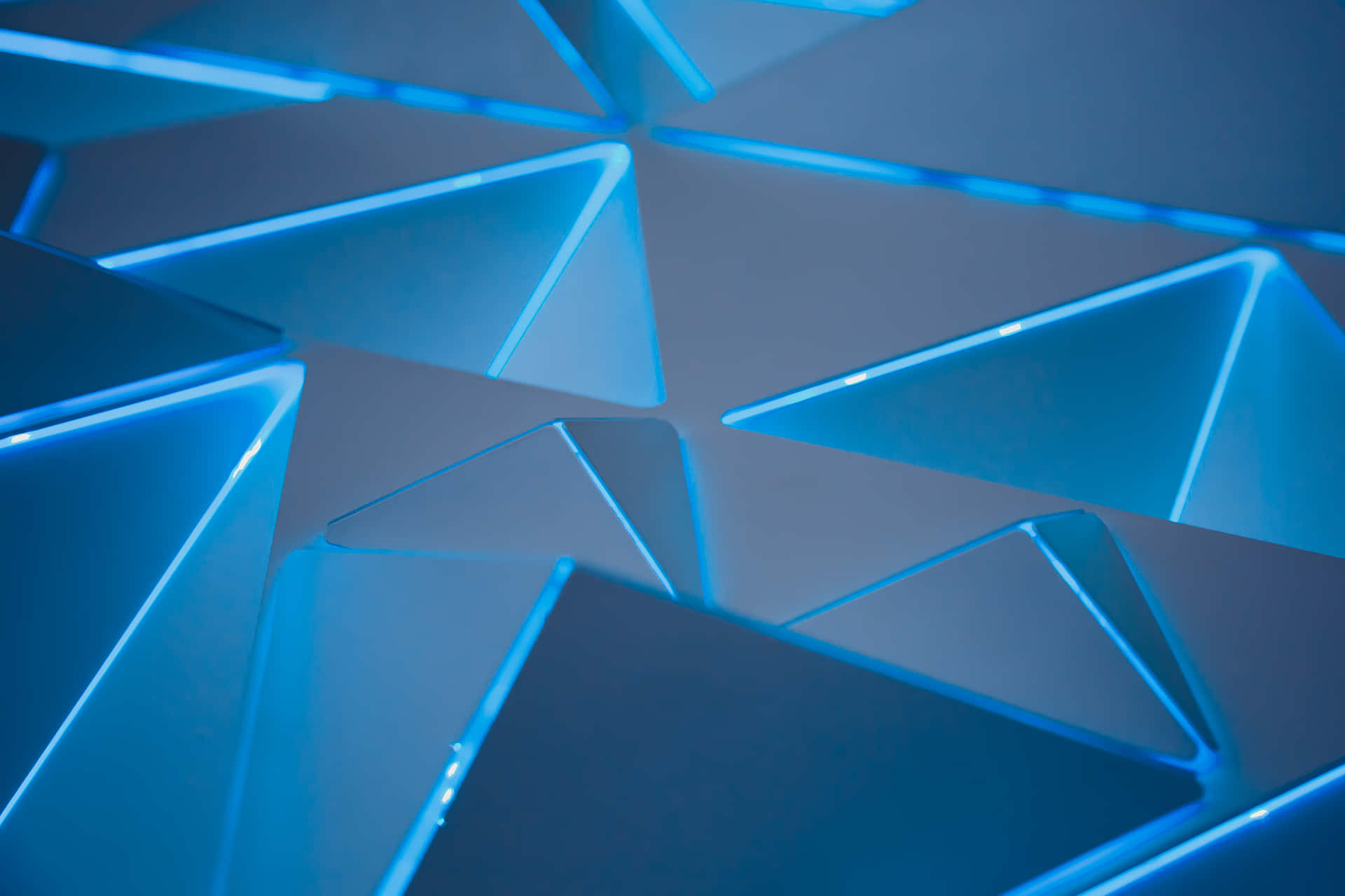 A Blue Light Is Shining On A Blue Geometric Pattern Wallpaper