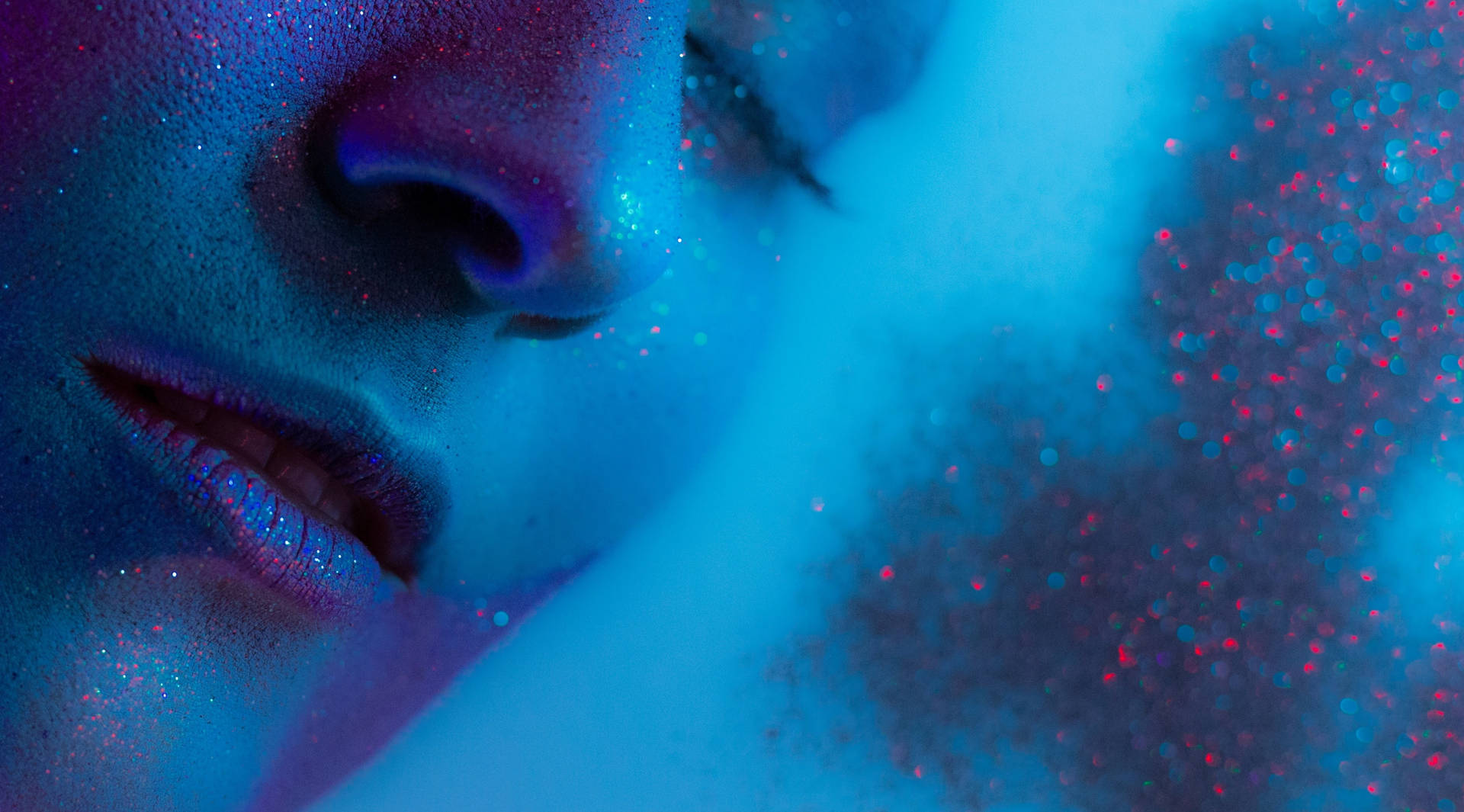 Blue Glitter On Woman's Face