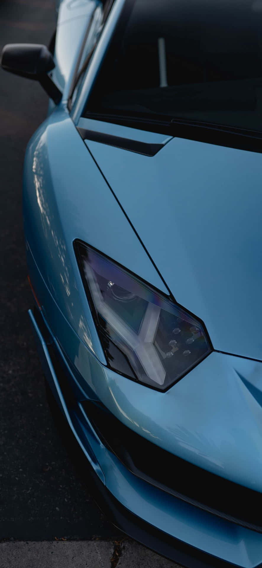 A Blue Sports Car Parked On The Street Wallpaper