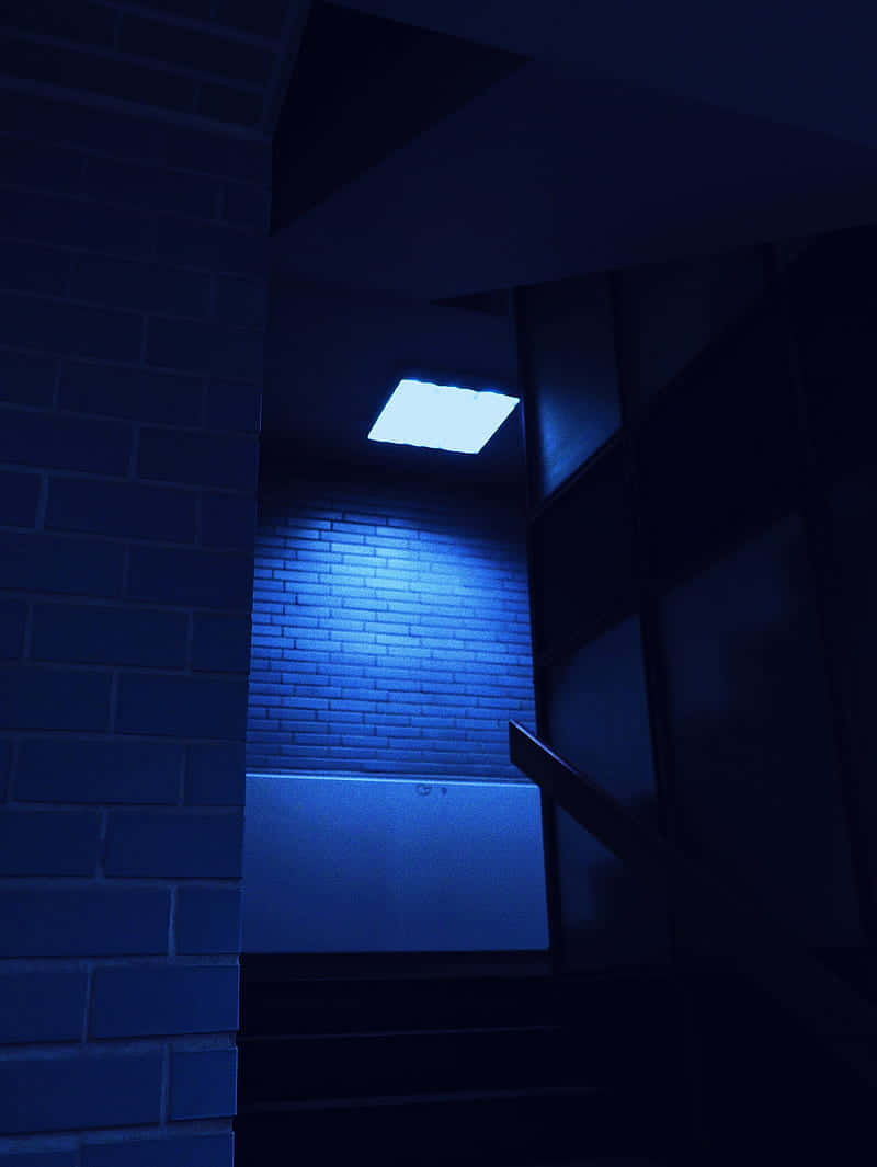 A Blue Light Is Shining On A Brick Wall Wallpaper