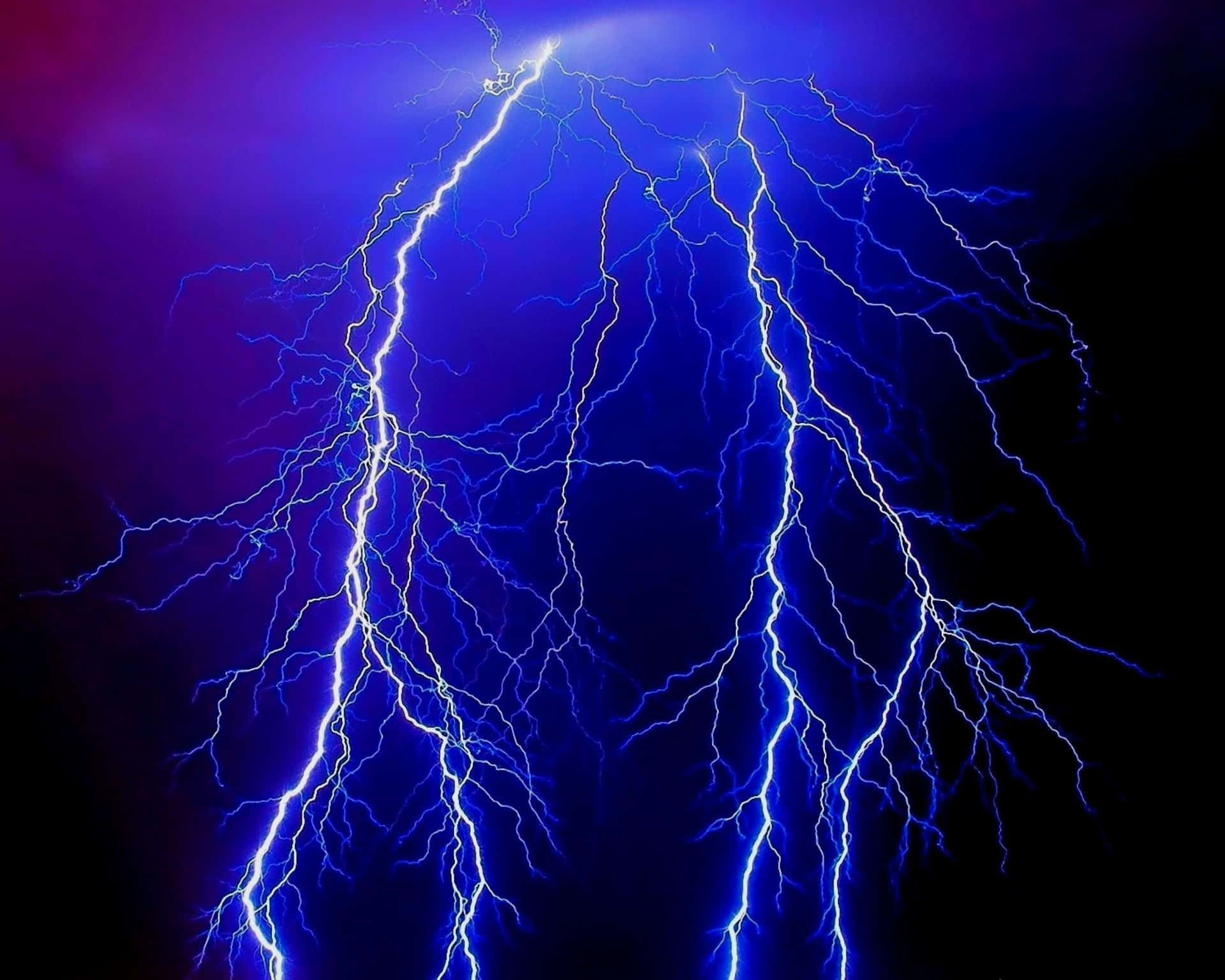 Blue lightning bolts electrifying the night sky.
