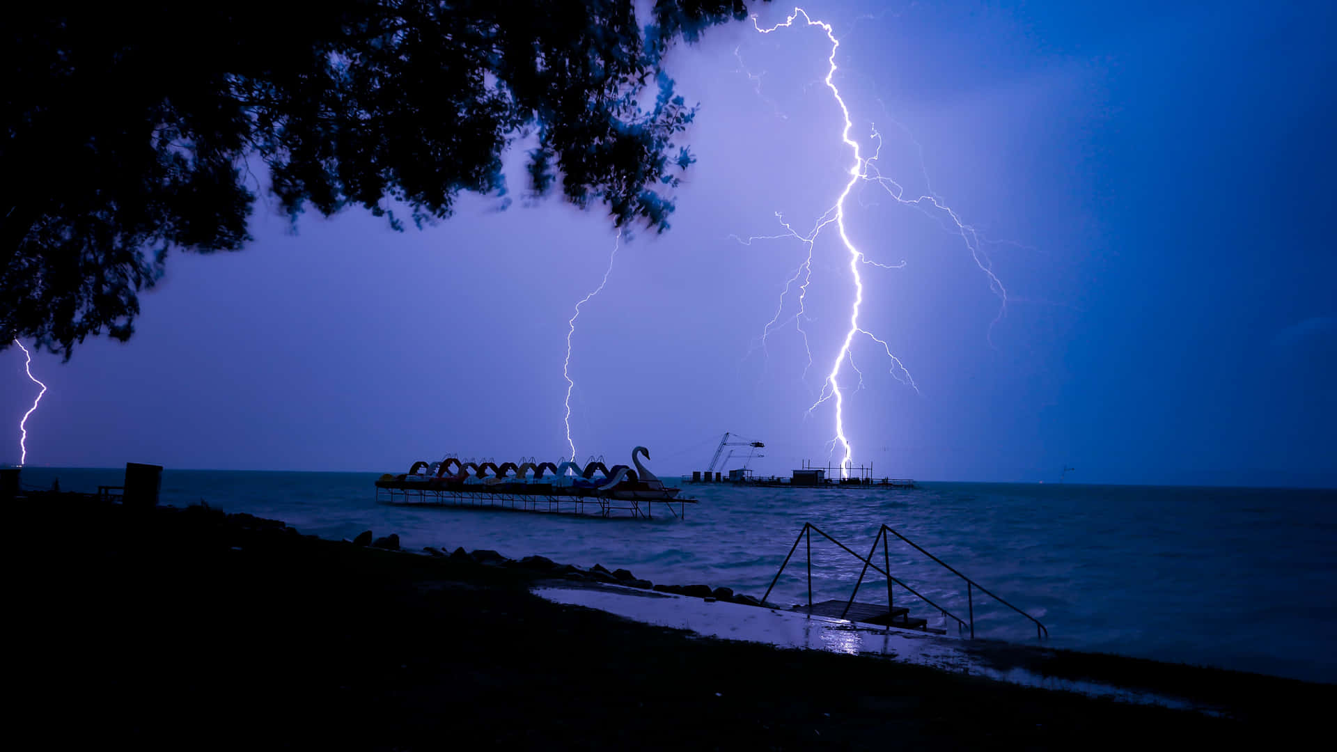 A striking blue lightning bolt against an indigo sky